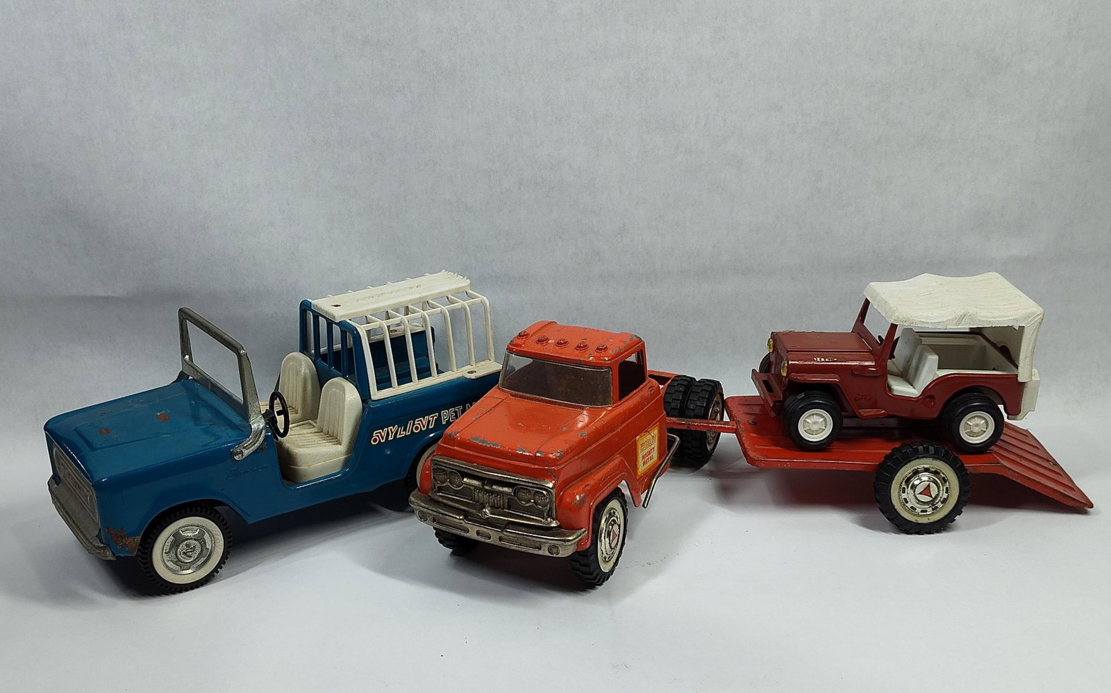 ThreeAmerican Toy Vehicles Including Nylint Bronco Pet Mobile, Hubley Mighty Metal Truck, and Tonka: This lot features threetoy vehicles of American manufacture. The first vehicle is a Nylint Ford Bronco Pet Mobile. The body is constructed of pressed steel finished in blue paint, featuring a white pl