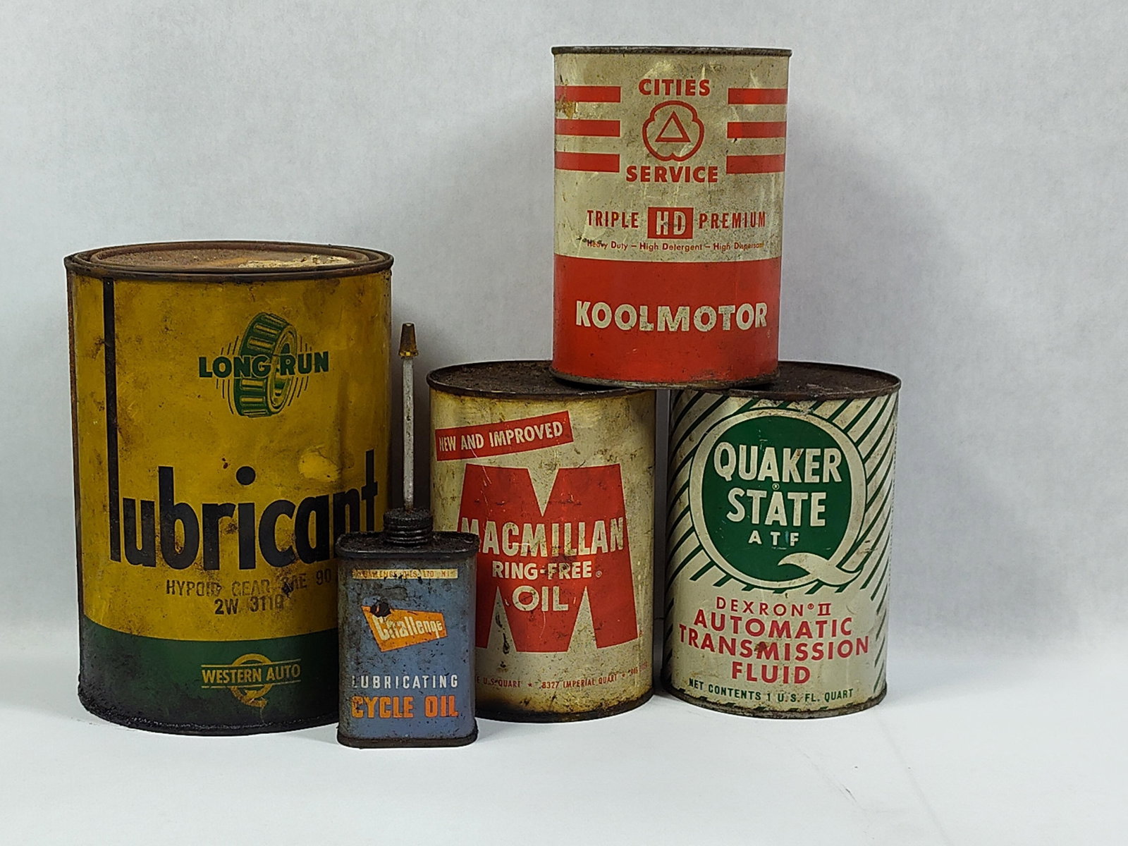 Mid-20th Century Automotive Oil and Lubricant Containers: This collection of automotive lubricant and oil containers dates from the mid-20th century and includes products from manufacturers such as MacMillan Petroleum Corporation, Cities Service, Quaker Stat