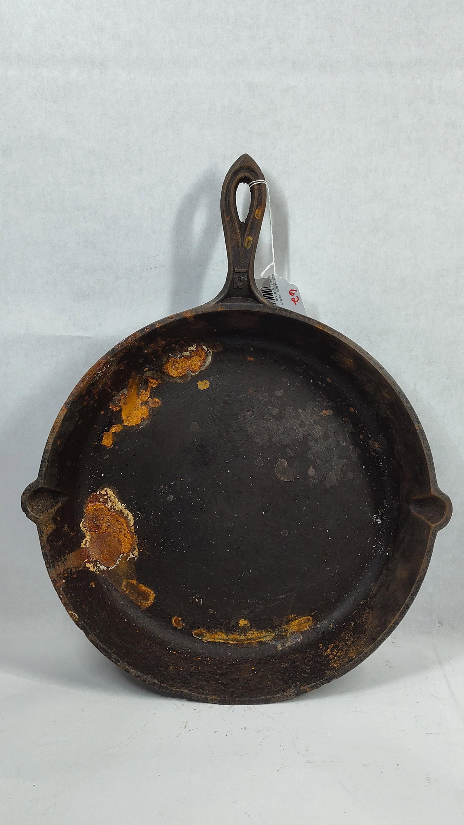 Antique No. 12 Gate-Marked Cast Iron Skillet with Fancy Handle and Inset Heat Ring: An antique cast iron skillet of large proportions, featuring a size 12 marking on the handle. The top of the handle at the join is marked with a horizontal bar, with the digit 1 positioned above and t