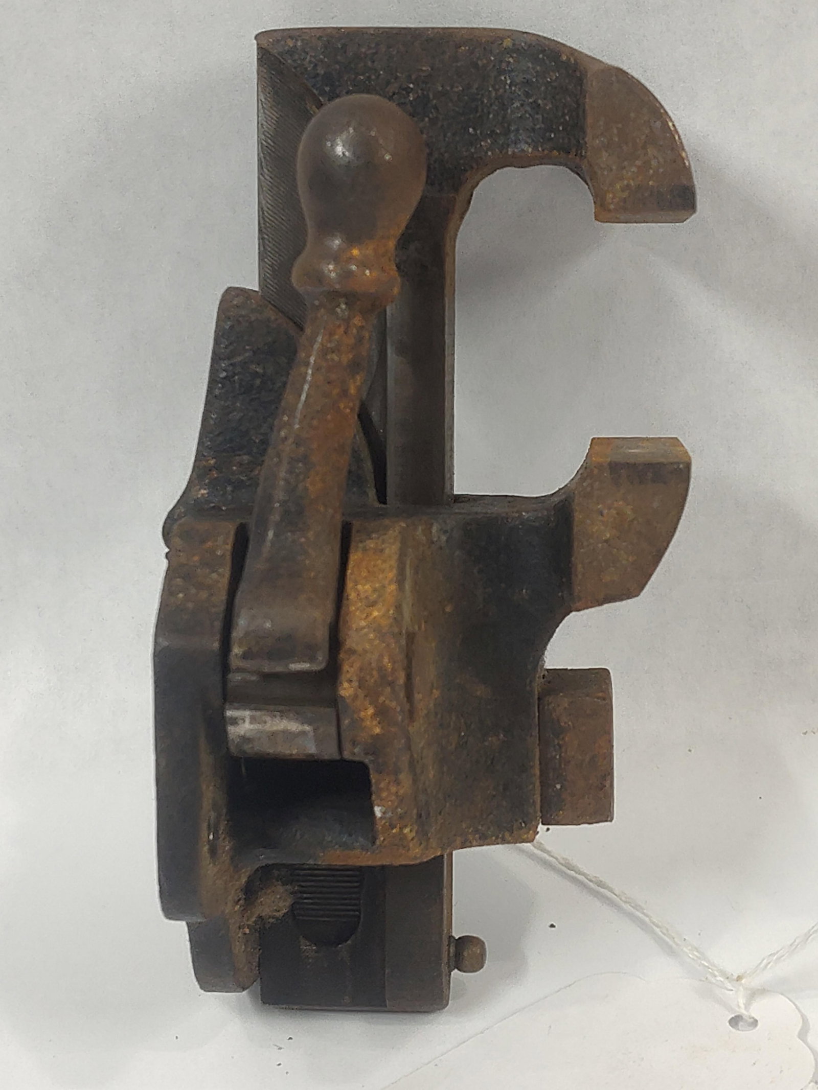 Antique Cam-Action Bench Vise Attributed to Stephens Patent: This tool is a cast iron cam-action workbench vise, attributed to the Stephens 1870 patent design. The mechanism utilizes a ball-end lever handle to actuate an internal cam for rapid clamping and rele