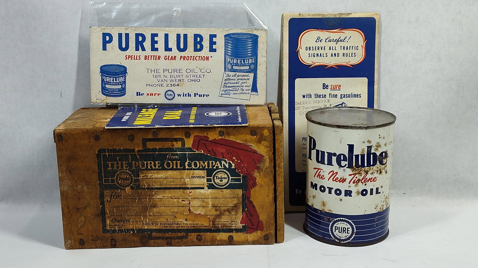 Pure Oil Company and Purelube Automobilia and Ephemera: This collection of petroliana consists of items related to The Pure Oil Company and its Purelube brand, dating to the mid-20th century. The group includes a small wooden shipping crate constructed wit