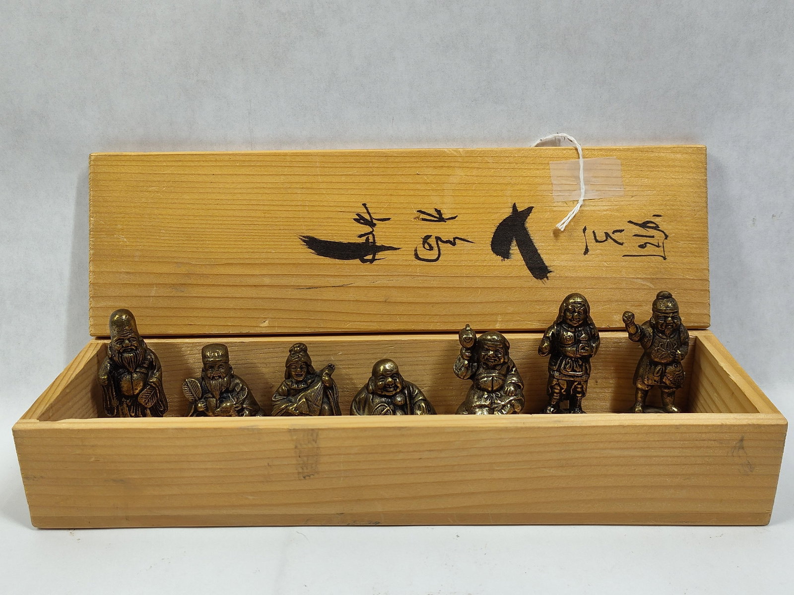 A Set of Japanese Cast Metal Shichifukujin Figurines in a Paulownia Wood Box (1 of 3)