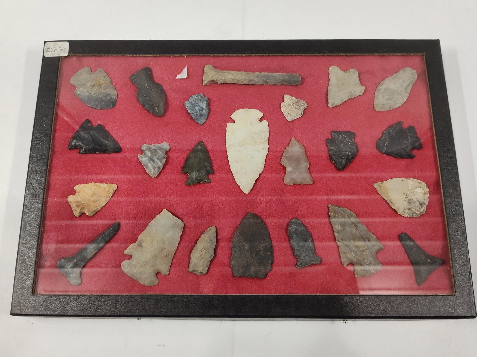 Twenty-Four Native American Lithic Artifacts from Ohio: This collection consists of twenty-four Native American lithic artifacts, primarily comprising projectile points and stone tools. The assembly includes a variety of prehistoric forms such as side-notc