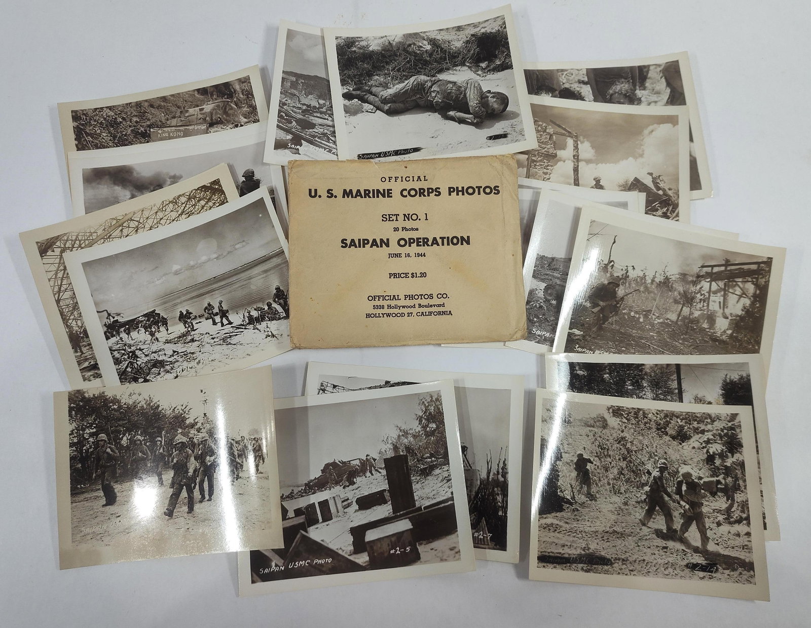 A Set of 20 World War II US Marine Corps Saipan Operation Official Photos with Original Envelope: This lot consists of a complete set of 20 black and white souvenir photographs documenting the United States Marine Corps Saipan Operation during World War II. The set is housed in its original