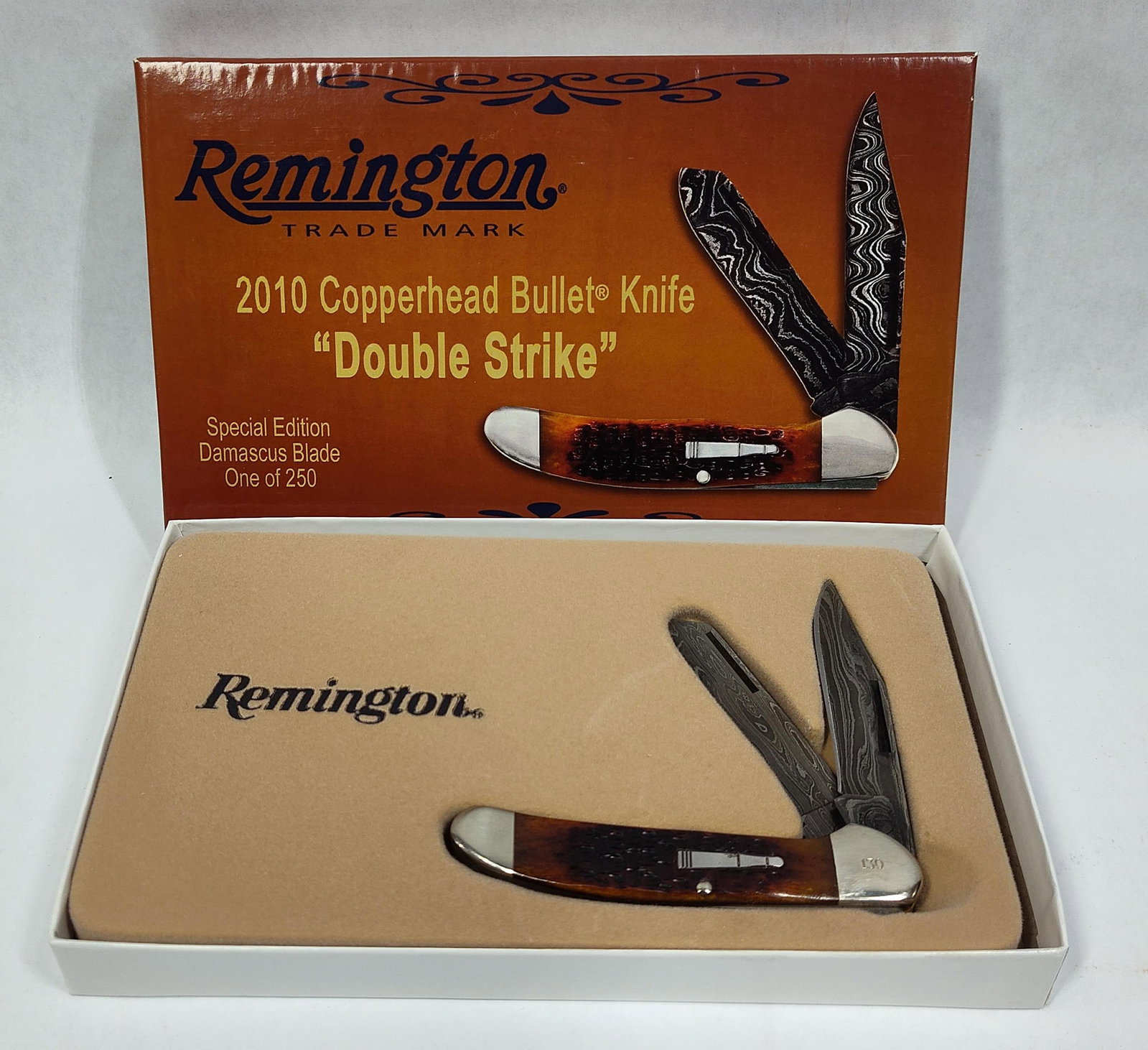 Remington 2010 Double Strike Copperhead Damascus Bullet Knife: Remington model R2253-D Double Strike Copperhead pattern pocket knife, produced in 2010 as a limited edition of 250 pieces. This specific specimen is serial numbered 130 on the front bolster. The