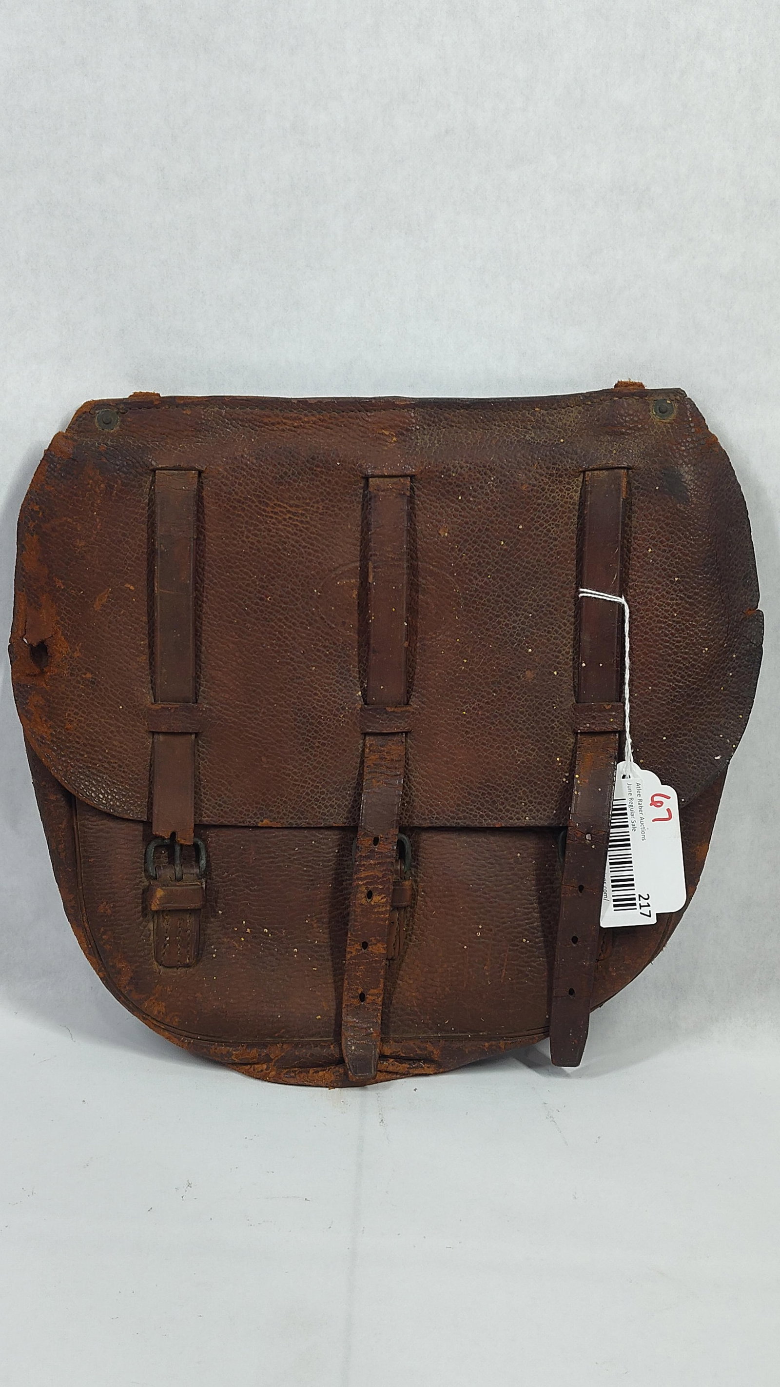 U.S. Military Model 1904 Pattern Cavalry Leather Saddle Bag: This is a single leather saddle bag, identified by its construction as a U.S. military Model 1904 cavalry pattern. The bag is made of dark brown leather and features a large top flap with a distinct