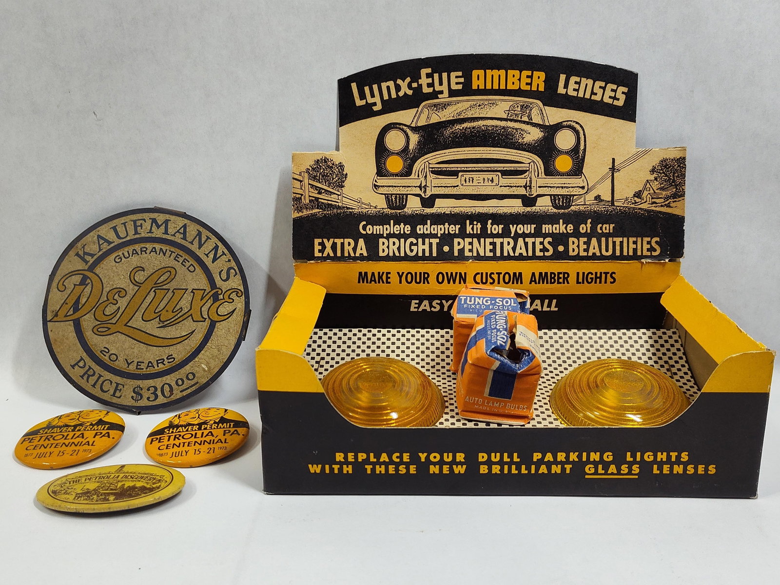 Collection ofAutomotive Accessories and Petrolia Pennsylvania Regional Memorabilia: This collection features mid-20th-century automotive aftermarket components and regional commemorative items from Pennsylvania. The primary item is a Lynx-Eye Amber Lenses point-of-sale countertop