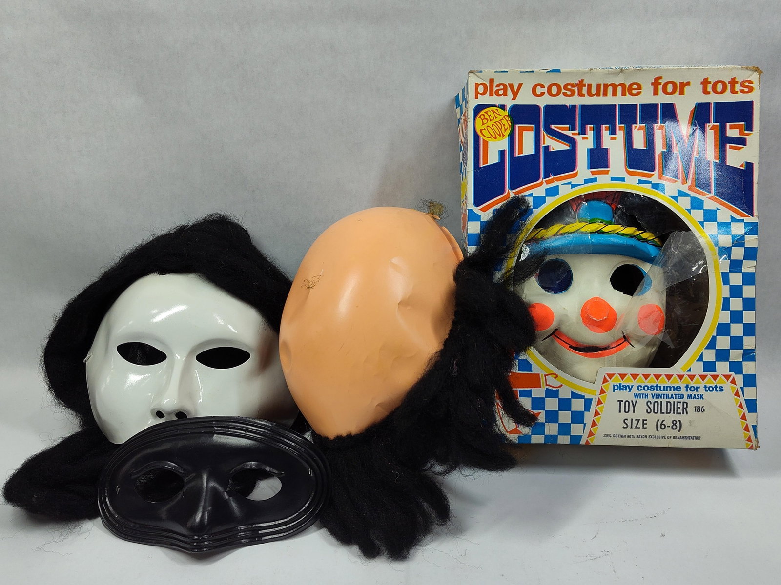 Halloween Masks and Boxed Ben Cooper Toy Soldier Costume: This lot includes aBen Cooper play costume for tots and three additional loose masks. The primary item is a Ben Cooper Toy Soldier set, model number 186, size 6-8. The set consists of the original car
