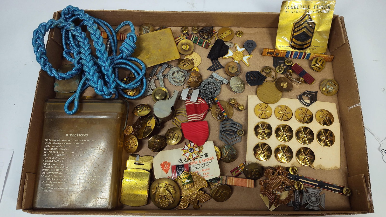 World War II and Post-War US Army Insignia, Medals, and Field Equipment: A large assortment of United States military memorabilia, primarily associated with the US Army and dating from the World War II era through the immediate post-war period. The collection includes a va