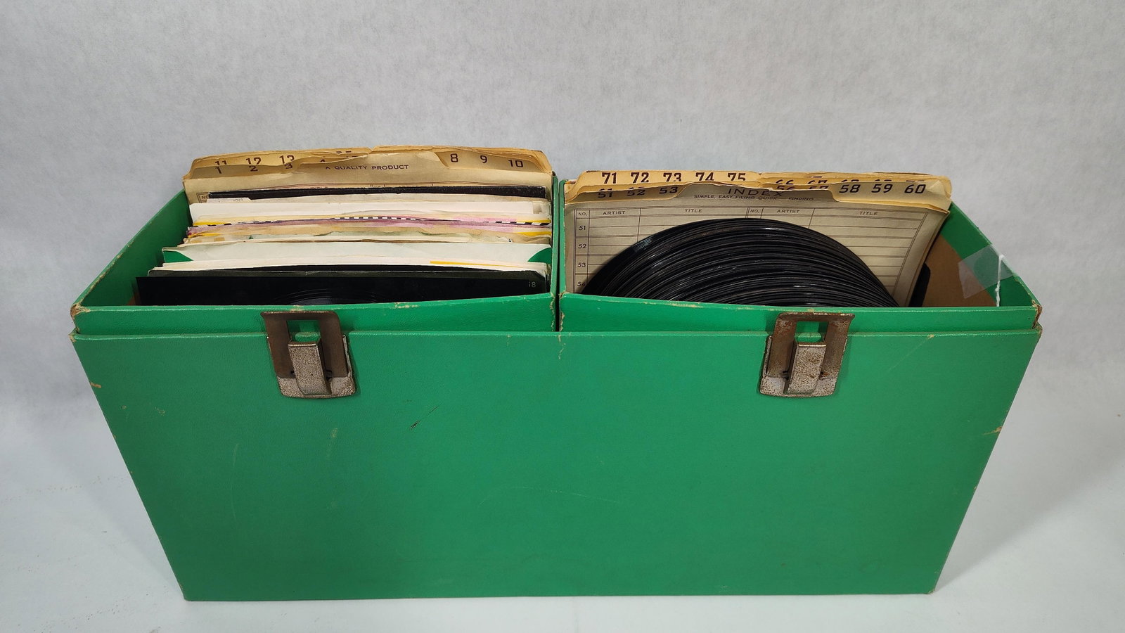 45 RPM Records in a Dual-Compartment Green Carrying Case: approximately 60?7545 RPM records and one 33 1/3 RPM flexi-disc, contained within a green textured vinyl carrying case. The collection features 1970s-era singles across various labels, including Unite