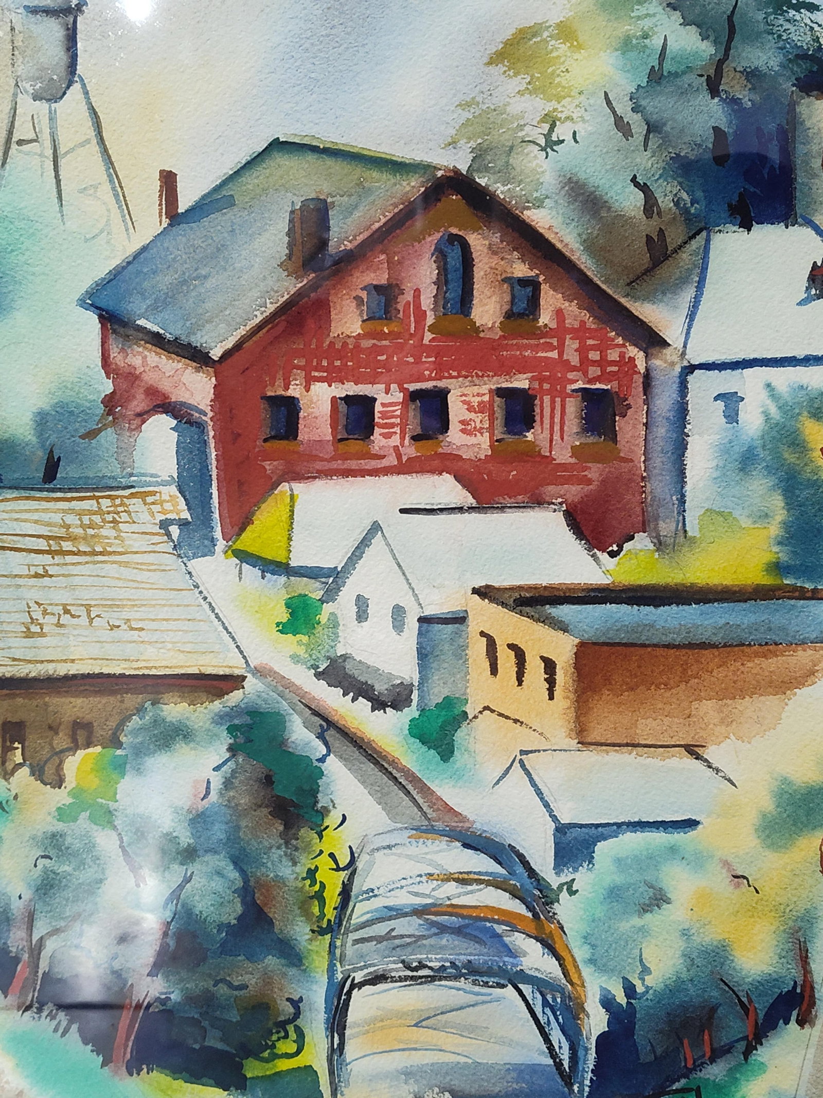 Attributed to Vas Hilyl, Modernist Townscape with Water Tower, Watercolor: This mid-20th-century watercolor on paper depicts a vibrant, stylized townscape in a modernist regionalist style. The composition is centered on a prominent multi-story red building with dark blue win