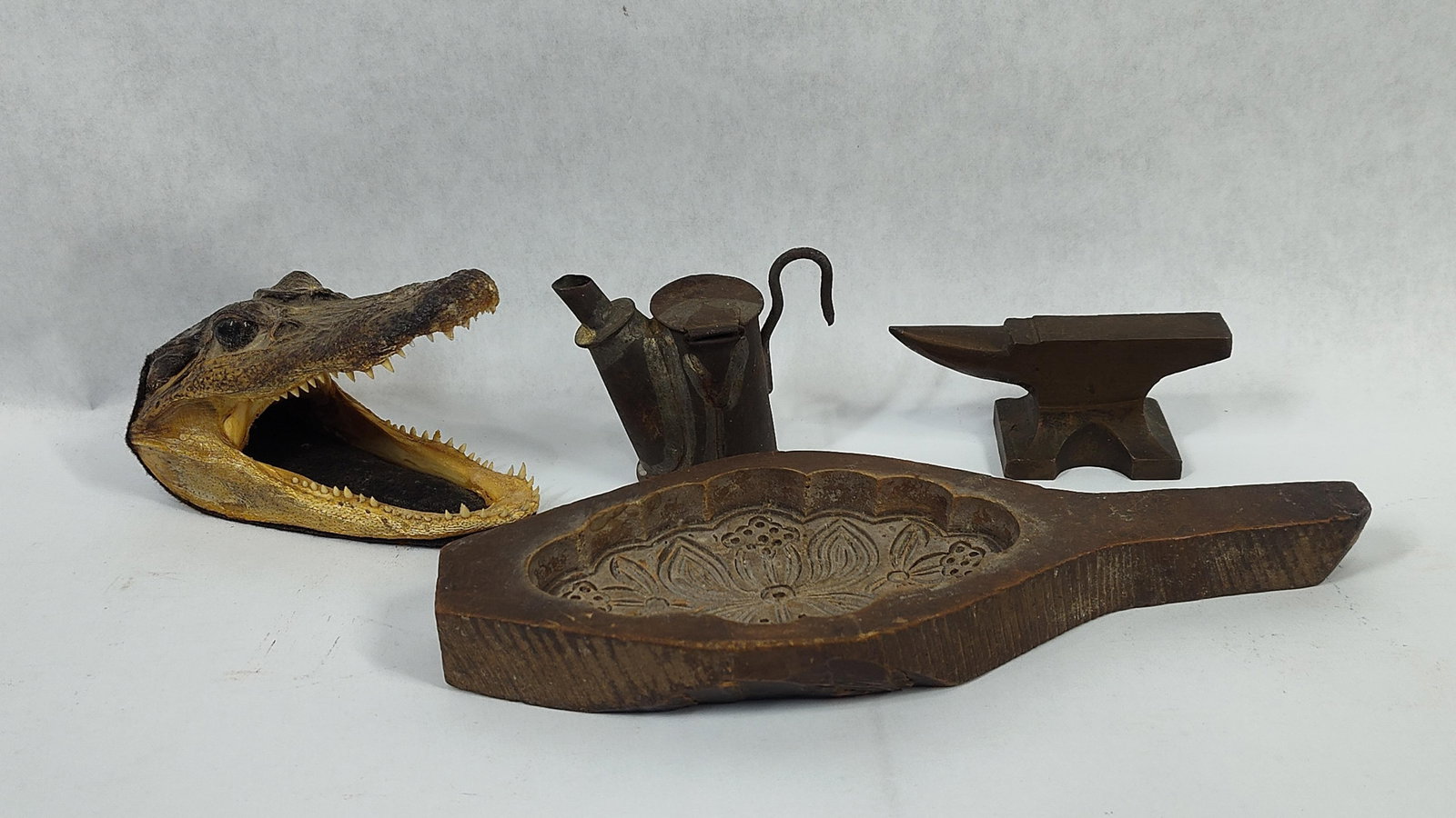 Assorted Curiosities Including a Taxidermy Alligator Head and Metalware: This collection features a variety ofand antique items including natural history, metalware, and folk art. The primary piece is a taxidermy head of an American Alligator (Alligator mississippiensis), 