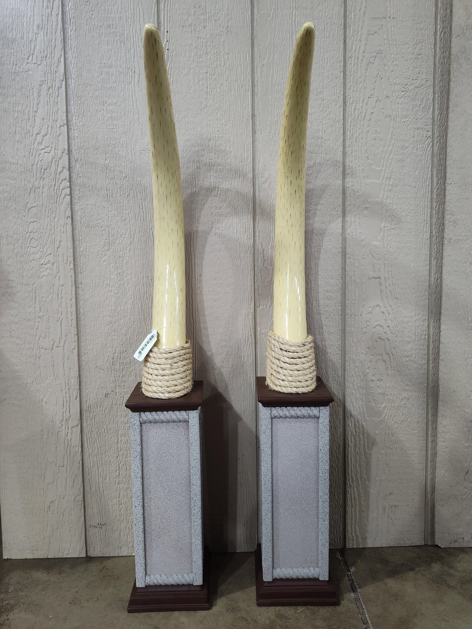 A Pair of Decorative Faux Elephant Tusks on Stone-Effect Pedestals (1 of 5)