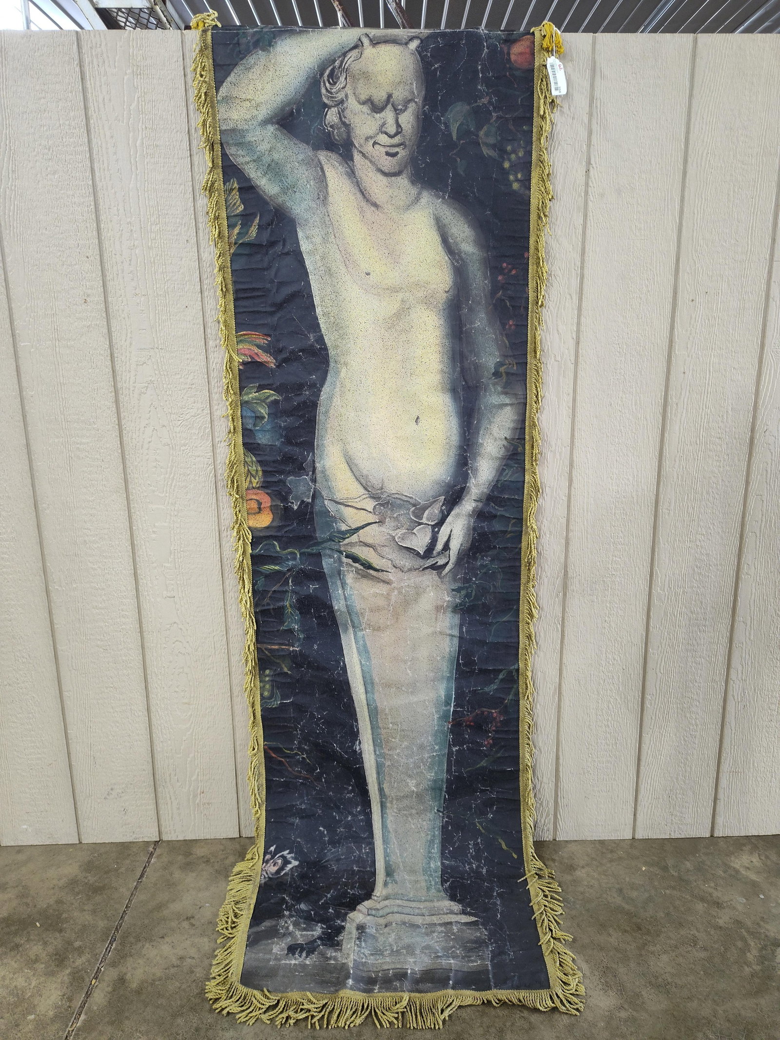 Mannerist Style Printed Textile Wall Hanging of a Satyr Herm: This decorative wall hanging features a printed textile panel depicting a terminal statue, or herm, of a satyr-like figure. The figure, shown with small horns and a subtle smile, transitions from a hu