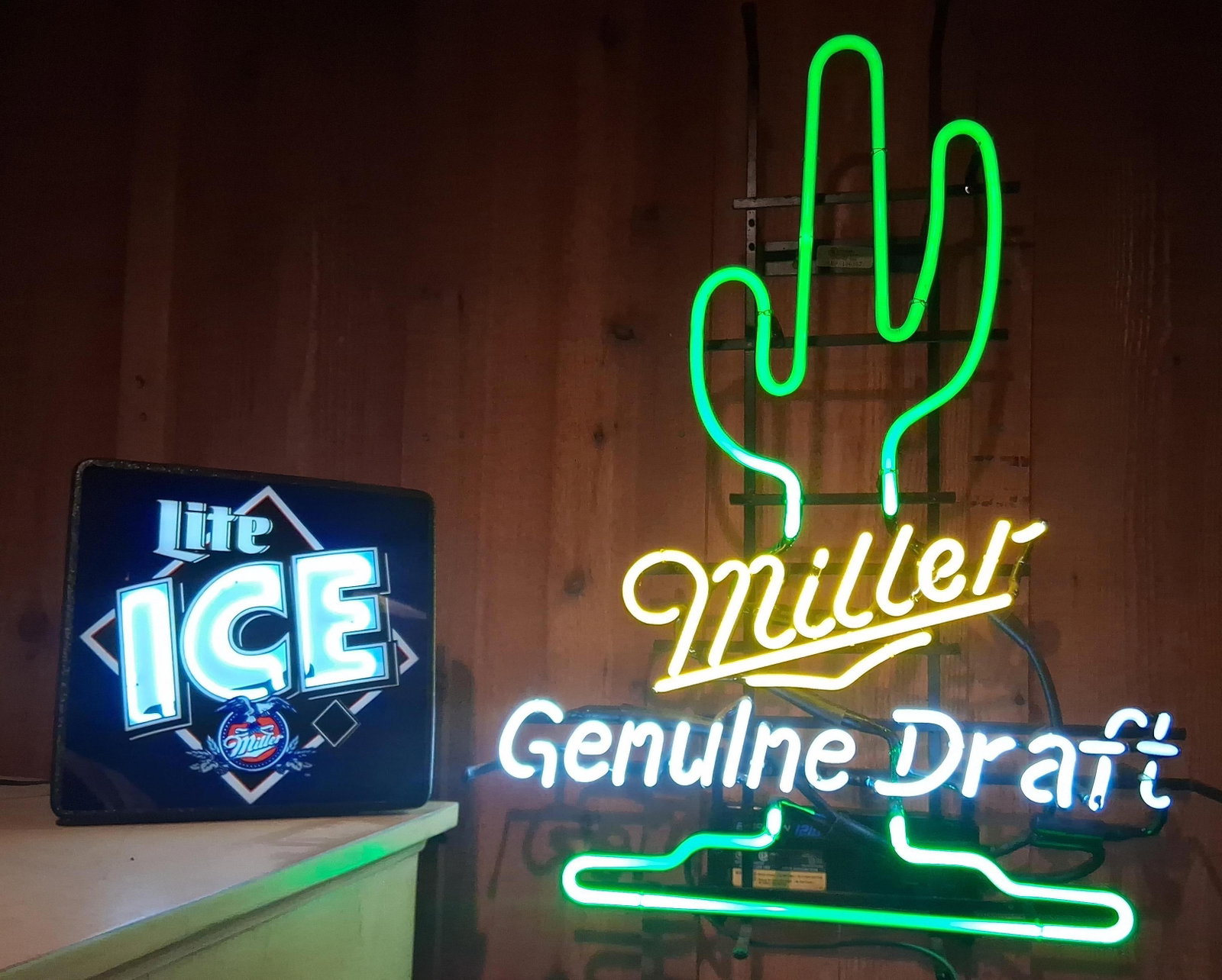 3 Miller Brewing Neon Signs & Mills Novelty Decal: Both are in working condition. This lot features three items related to breweriana and coin-operated novelty machine history. The first item is a Miller Genuine Draft neon advertising sign. The