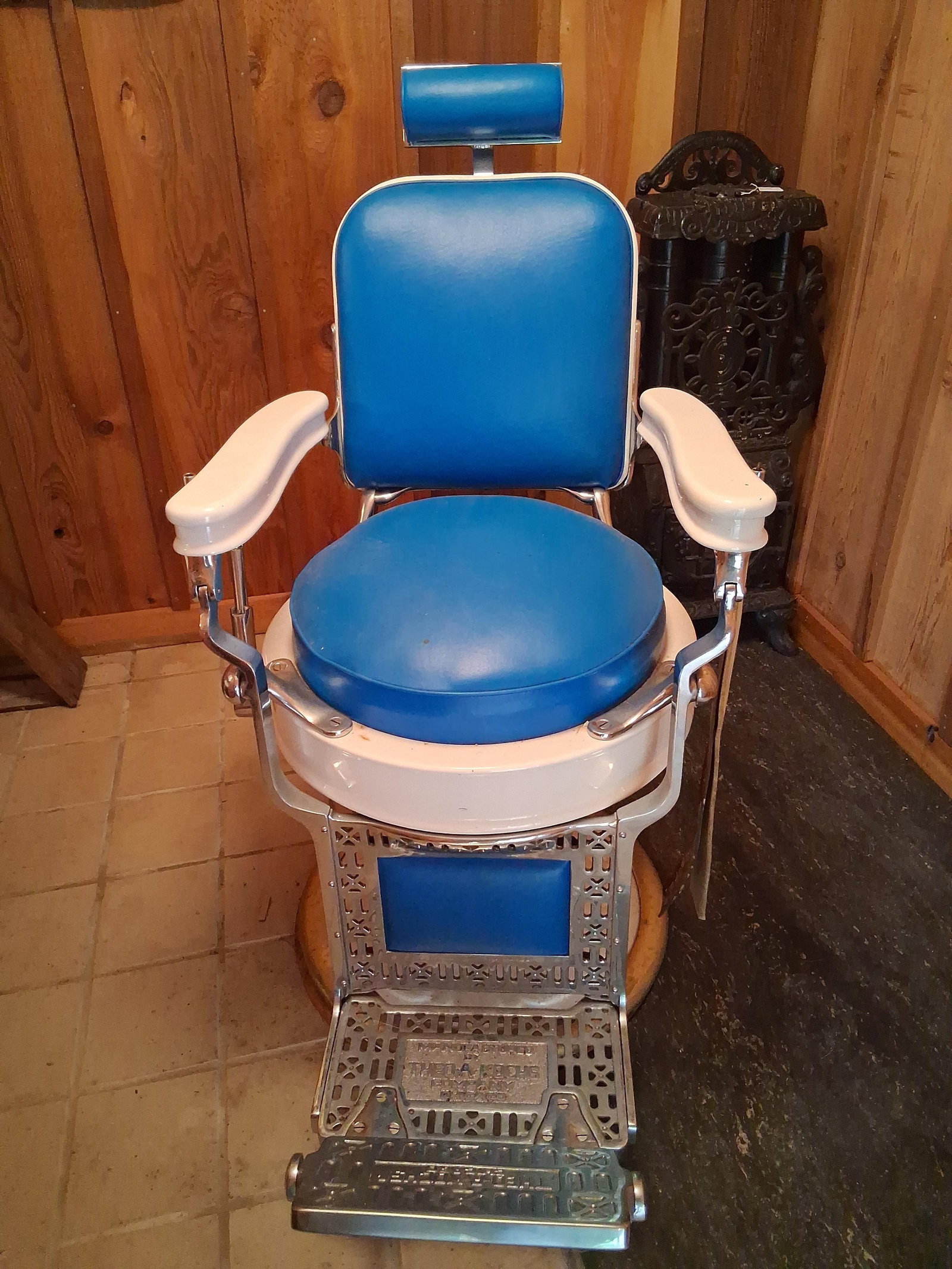 Theo. Kochs Porc. Enamel & Cast Iron Barber Chair: This is a professional vintage barber chair manufactured by the Theo. A. Kochs Company of Chicago. The chair is constructed with a heavy cast-iron frame and a circular pedestal base, both finished in 