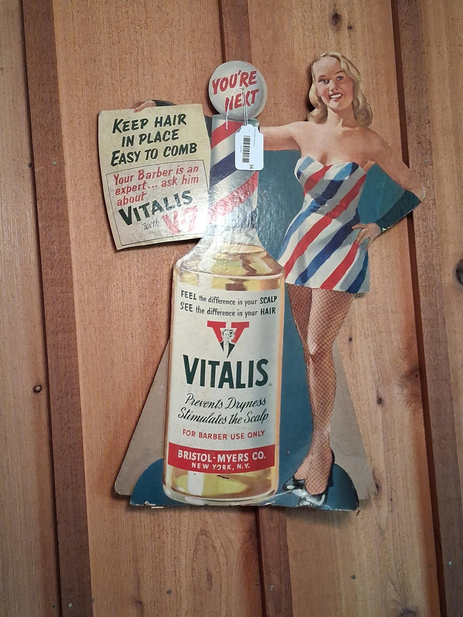 Vitalis Hair Tonic Display & 1940 Rexall Calendar: This lot consists of two vintage promotional advertising pieces. The first item is a circa 1950s die-cut cardboard countertop easel-back display for Vitalis hair tonic, manufactured by the
