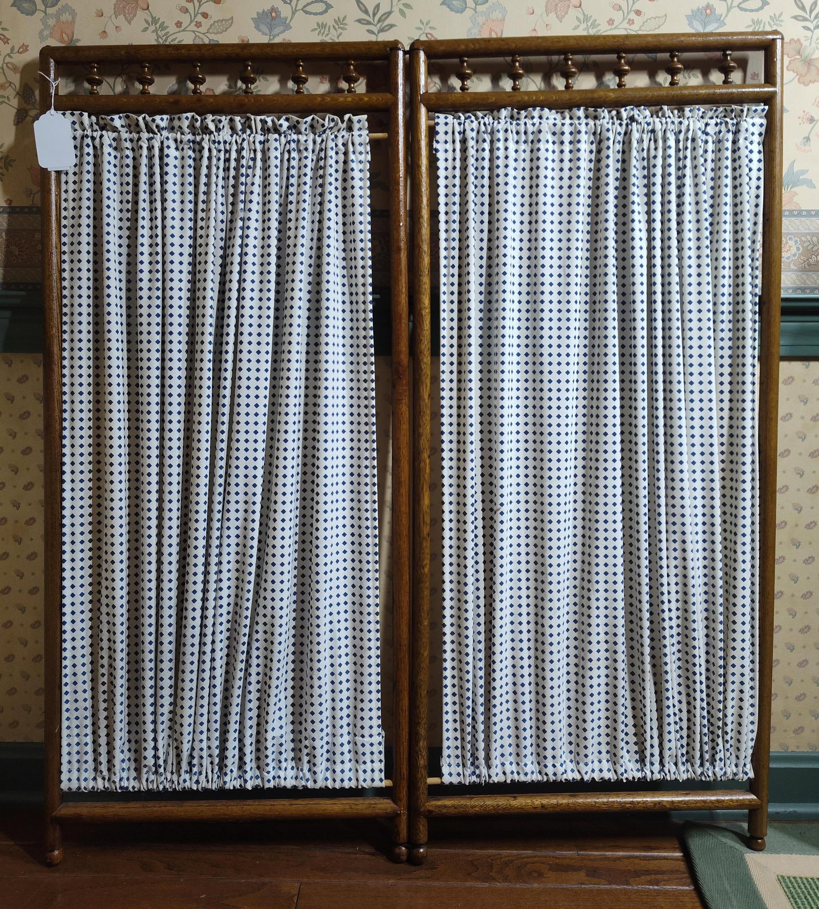 Two-Panel Colonial Revival Stained Hardwood Screen: This two-panel folding room divider screen is designed in the Colonial Revival style. The frame is crafted from stained hardwood featuring a warm medium-brown finish. Each panel is topped with a