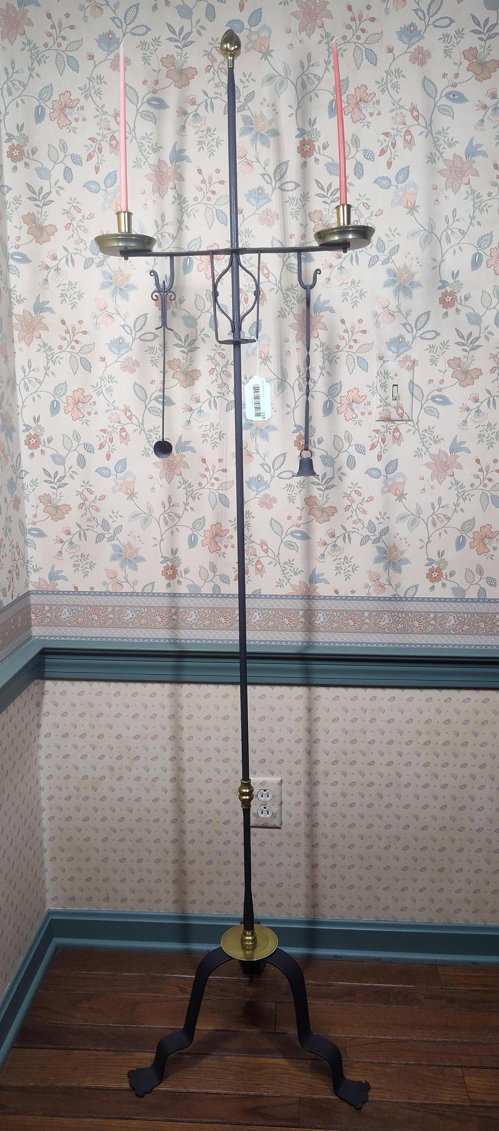 Colonial Revival Iron & Brass Floor Candelabrum: A Colonial Revival style floor-standing candelabrum constructed of wrought iron with a black finish and polished brass accents. The piece features a central vertical shaft supported by a tripod base