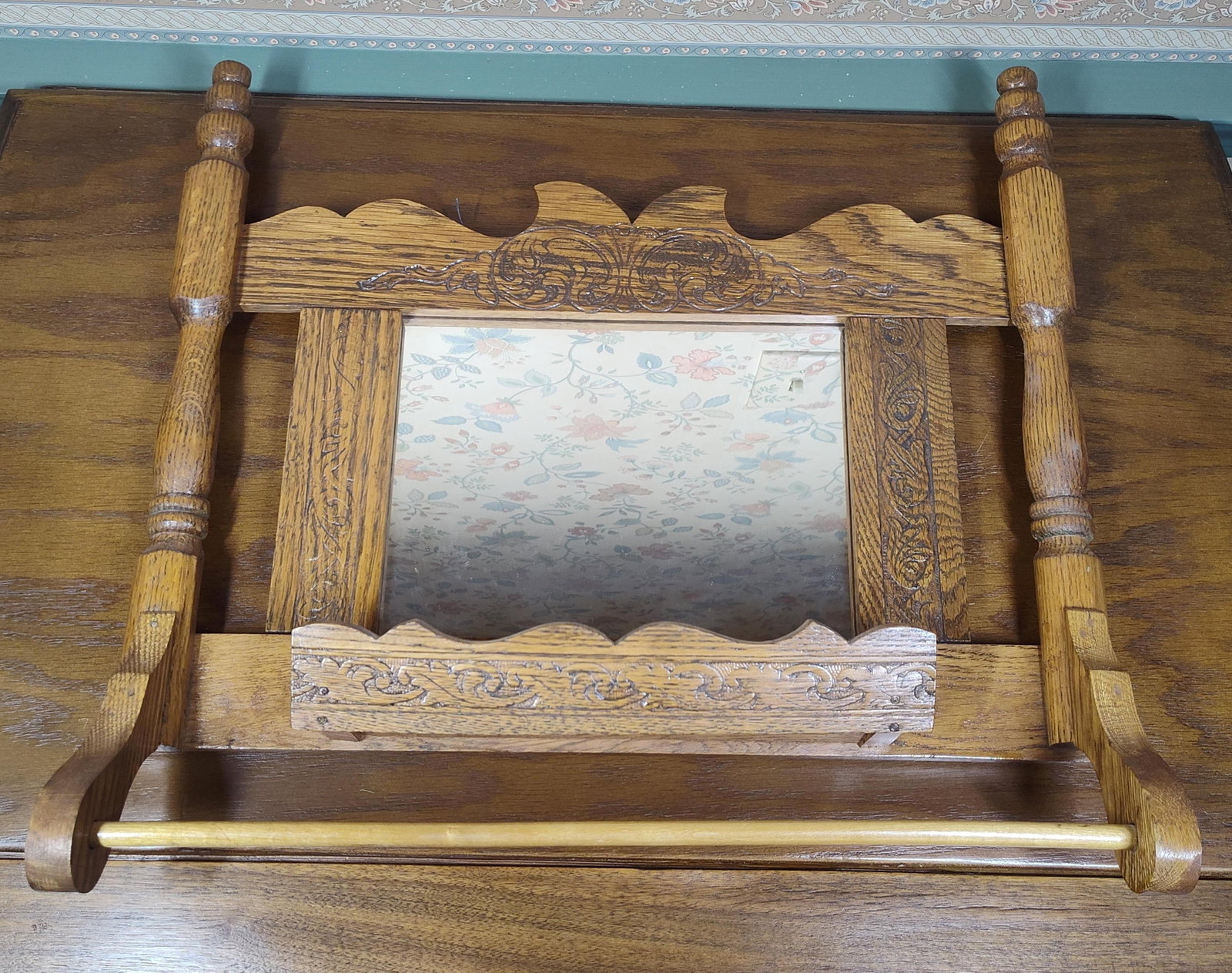 Victorian Style Pressed Oak Mirror w/ Towel Bar: 18x 16.5. This wall-mounted vanity rack, frequently categorized as a shaving or comb and brush mirror, is constructed of oak and features decorative machine-pressed elements characteristic of the