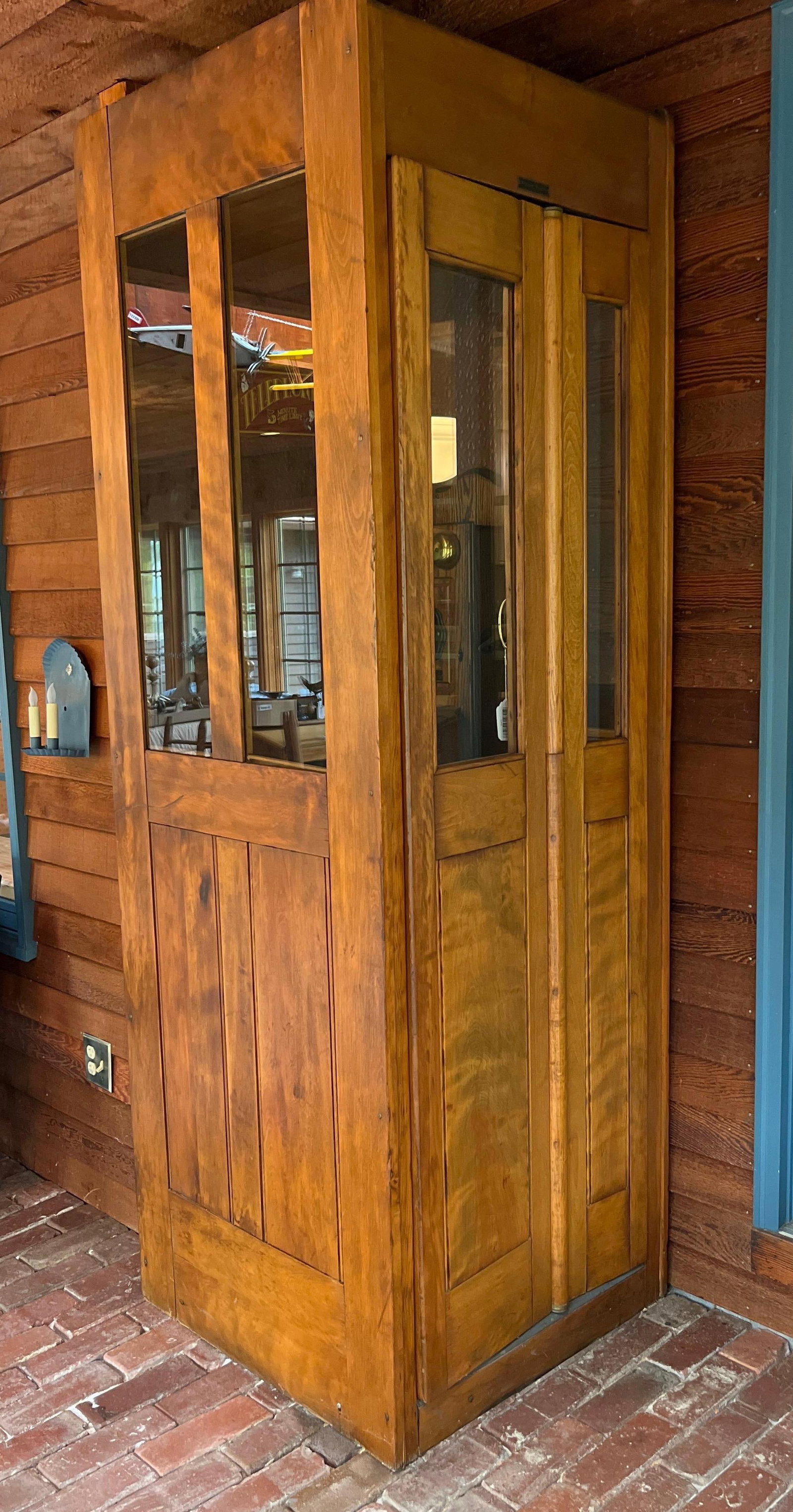 C.B. French Cabinet Co. Oak Magneto Phone Booth: This antique indoor telephone booth was manufactured by the C.B. French Cabinet Co. Inc. of Brooklyn, New York, during the early 20th century. The single-piece upright cabinet is constructed of solid 