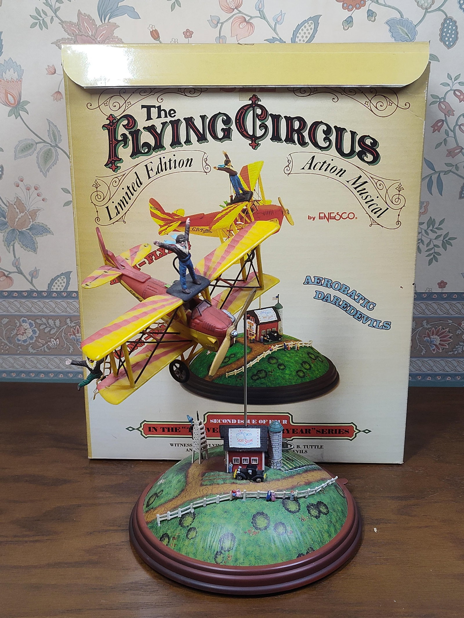 Enesco Flying Circus Action Musical: This collectible action musical, titled The Flying Circus, was produced by Enesco Imports Corp. in 1987 as the second issue of four in the Travels of Yesteryear series. The piece is designed by M. Gil