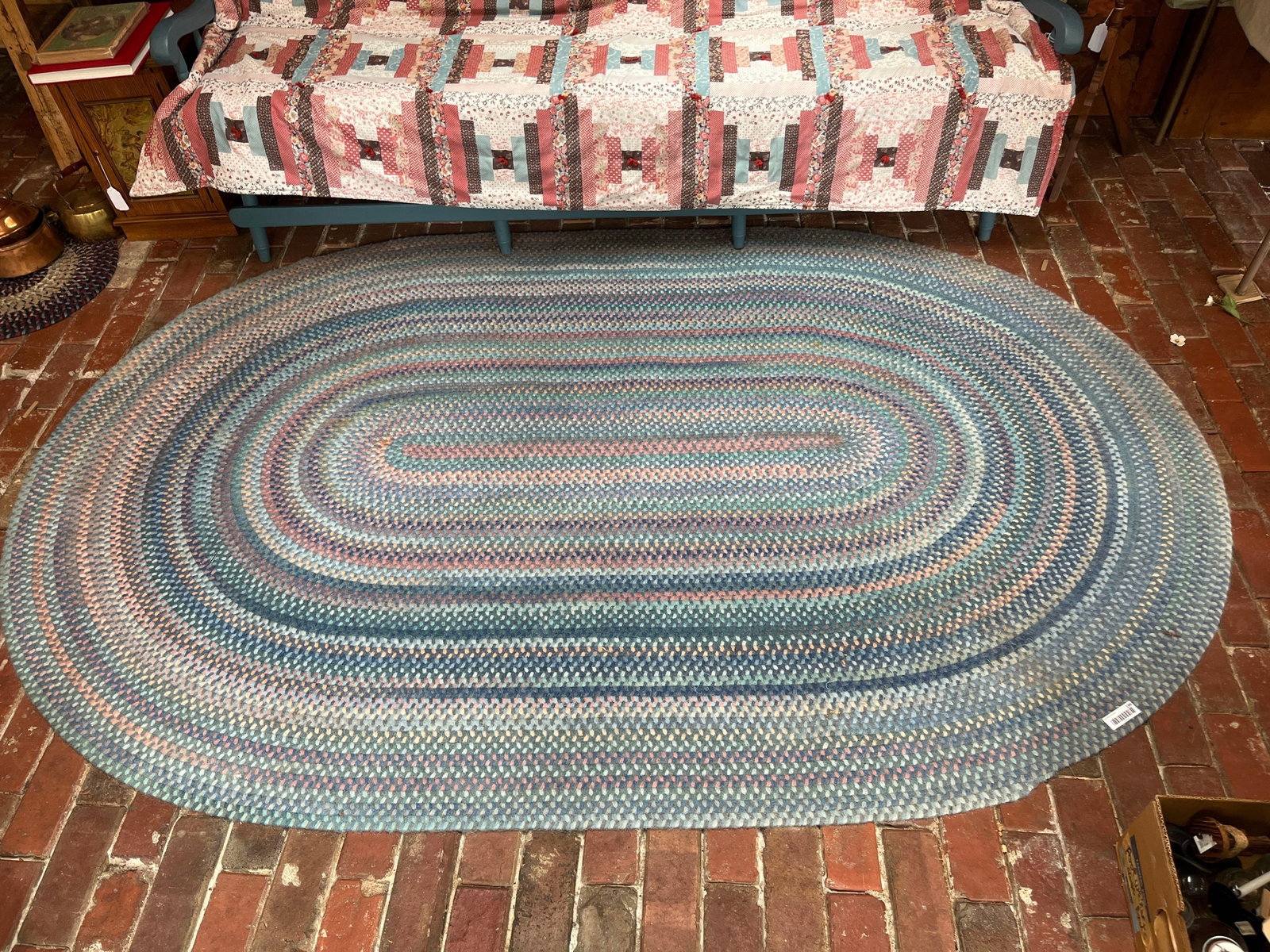 Large American Oval Braided Multi-Color Area Rug: 101x 67. This is a large oval braided area rug in the traditional North American style. The rug is constructed from continuous, concentric bands of braided fabric strips, typically made of wool or a w