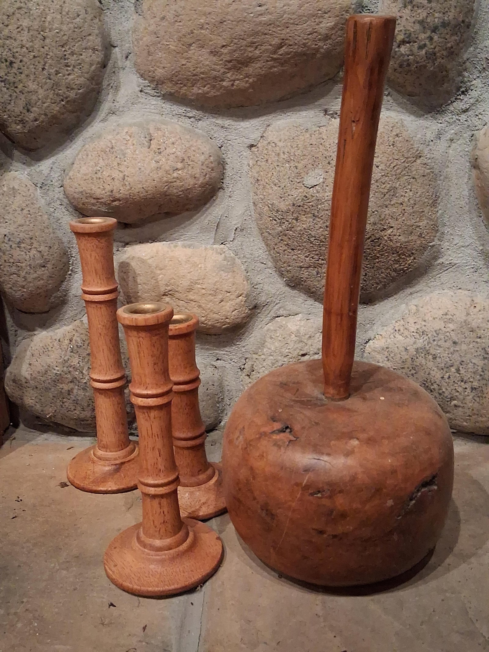 Turned Wood Mace & Graduated Candlesticks: A group of turned wooden objects comprising a traditional exercise mace and graduated candlesticks. The exercise mace, also known as a gada, features a heavy, bulbous head crafted from highly figured 