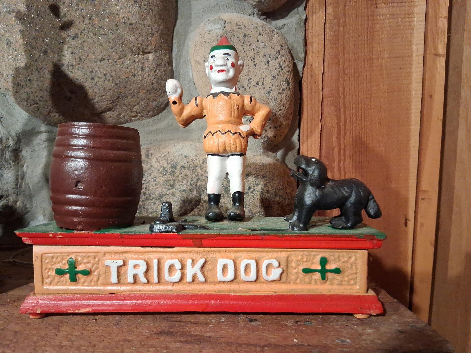 Trick Dog Mechanical Bank: This is a Trick Dog mechanical bank, a cast iron coin-saving device featuring a design in the style of late 19th-century mechanical banks. The bank is constructed from painted cast iron components and