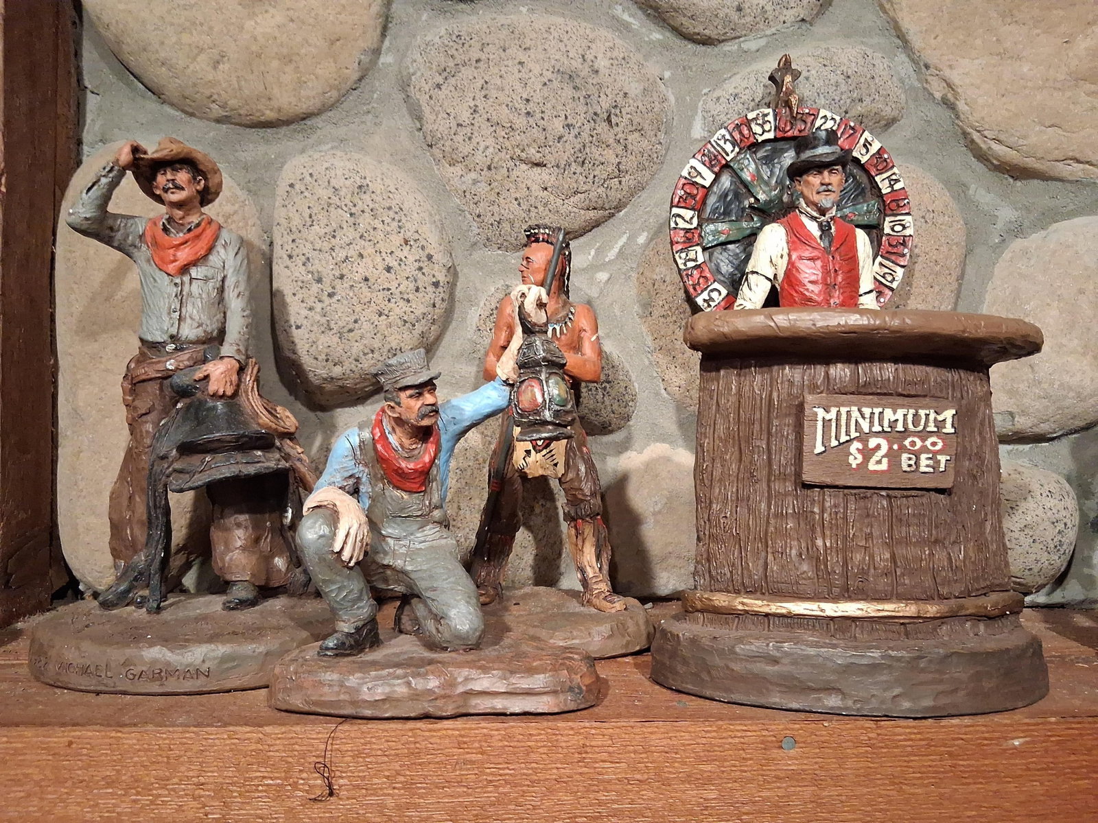 Michael Garman Hand-Painted Western Sculptures: This collection features hand-painted Americana-style sculptures produced by Michael Garman Productions in Colorado Springs, Colorado. The group includes four distinct figures depicting Western and