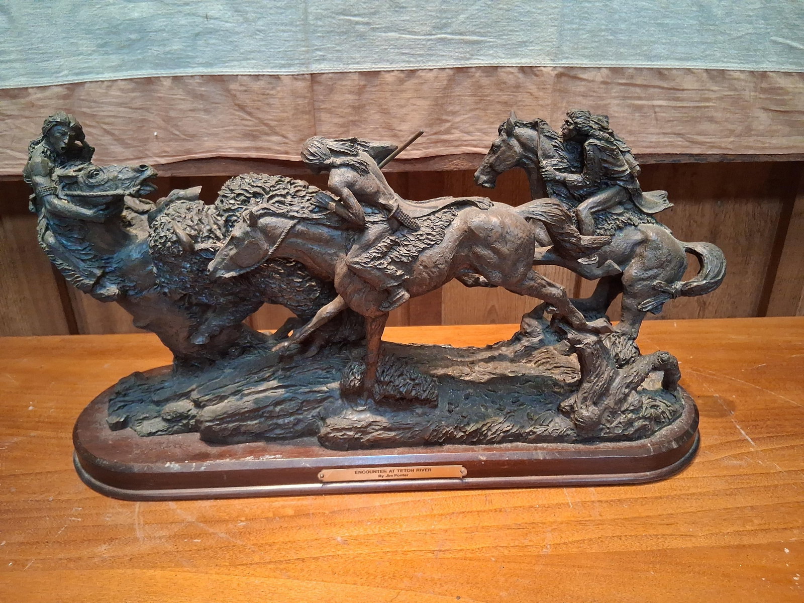 Jim Ponter, Encounter at Teton River, Bronze: This contemporary Western sculpture, titled Encounter at Teton River, was created by artist Jim Ponter. The composition depicts a dynamic bison hunt featuring three Native American hunters on