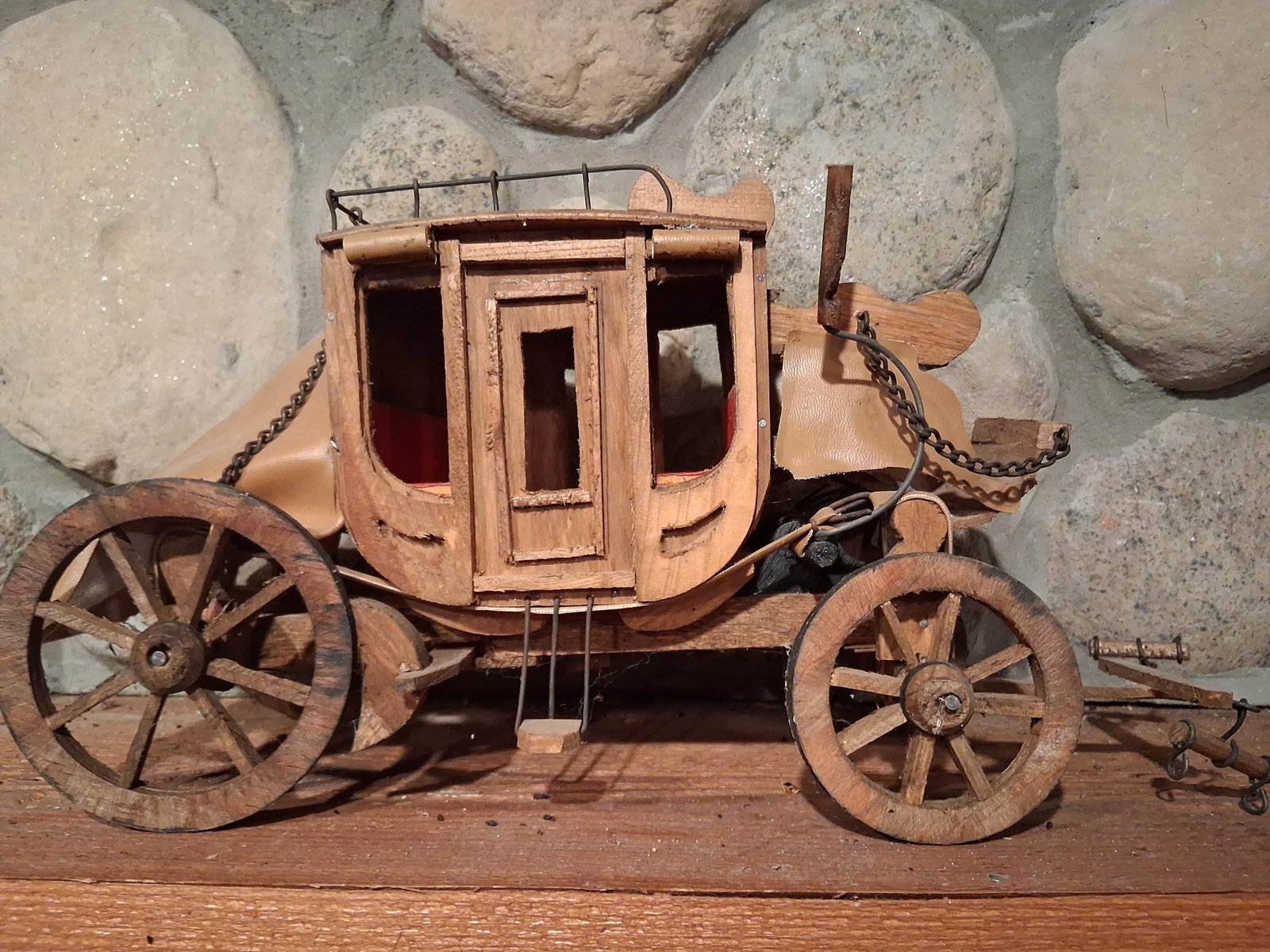 American Concord Stagecoach Wooden Model: This is a vintage wooden display model of a nineteenth-century American Concord stagecoach. The piece is constructed primarily of wood, including the passenger cabin, chassis, spoked wheels, and