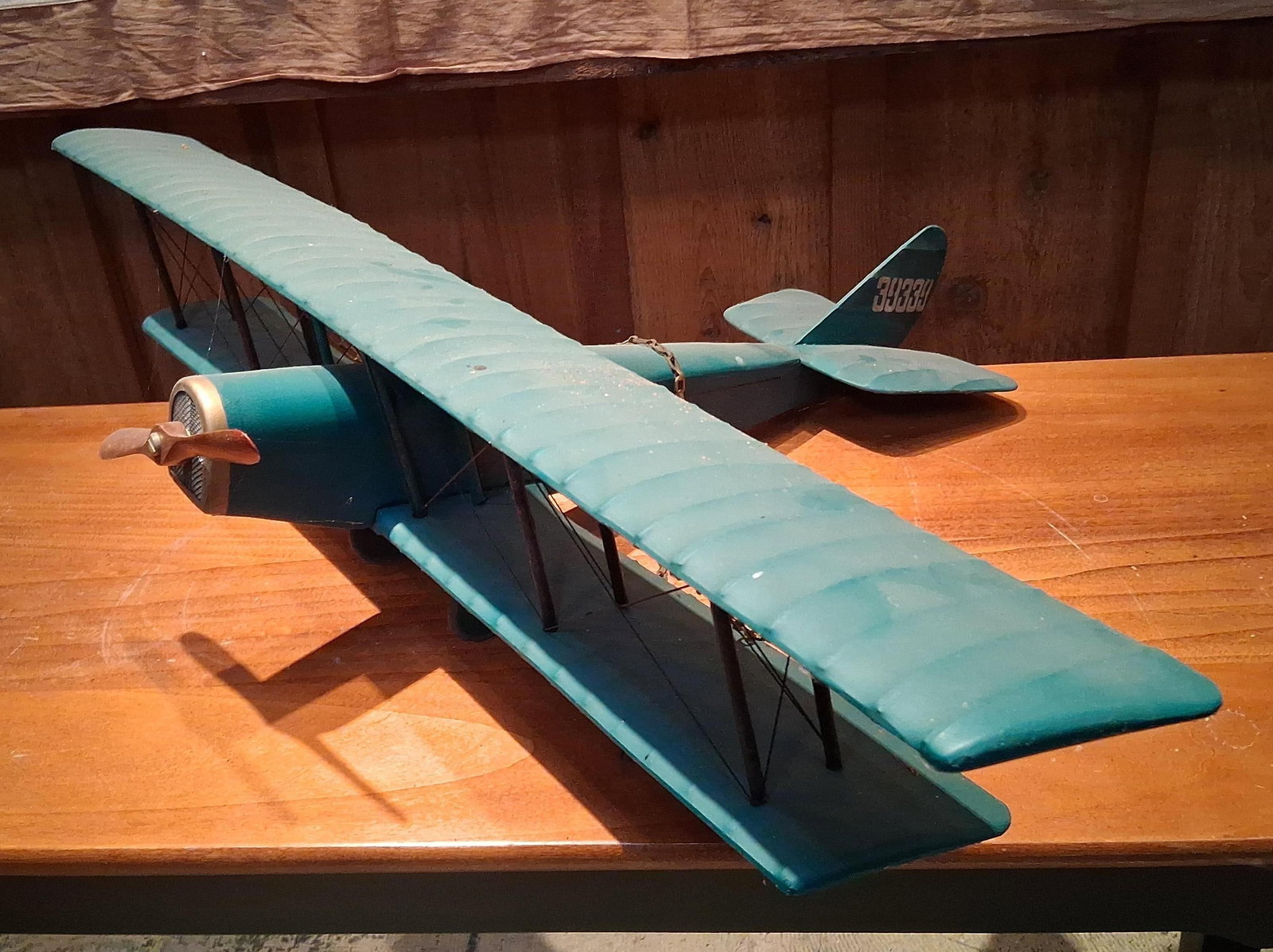 Painted Sheet Metal Model Biplane w/ Fleur-de-Lis: This is a large-scale decorative model of a biplane, designed in the style of a World War I-era scout fighter such as a French SPAD. The aircraft is primarily constructed from formed sheet metal and f