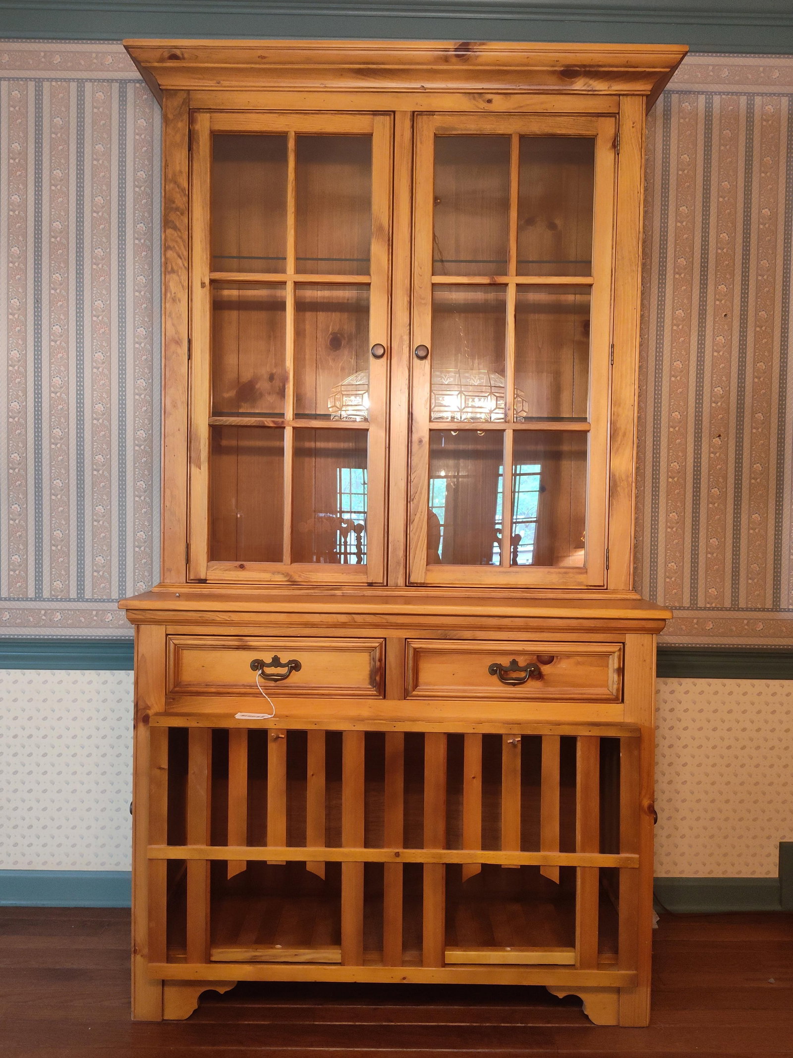 Two-Piece Pine Irish Chicken Hutch Style Dresser: 44x 81x 19. A two-piece pine hutch or china cabinet designed in the style of a traditional Irish chicken coop dresser. The upper section features a cabinet with two doors, each containing six clear gl