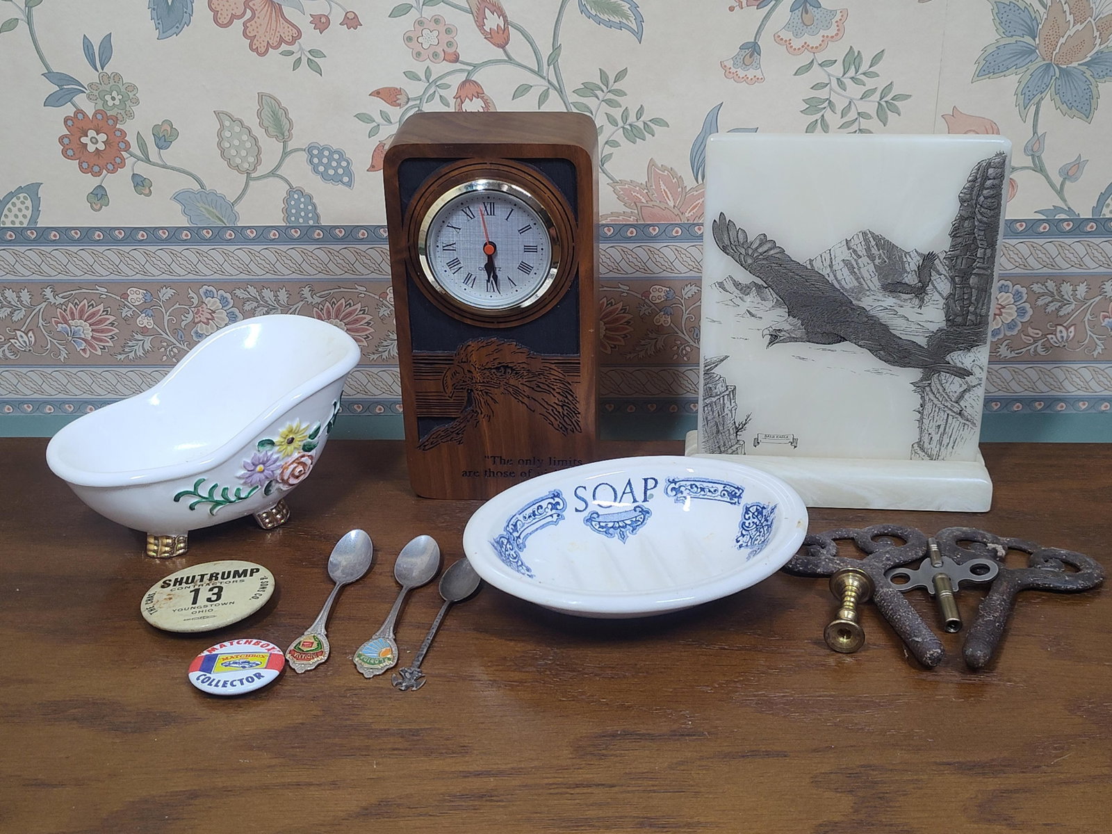 Olivenhain Marble Plaque, Wood Clock & Ceramics: This collection features a variety of decorative and commemorative objects. Included is a wooden quartz desk clock with a carved eagle motif and the inscribed quote, The only limits are those of