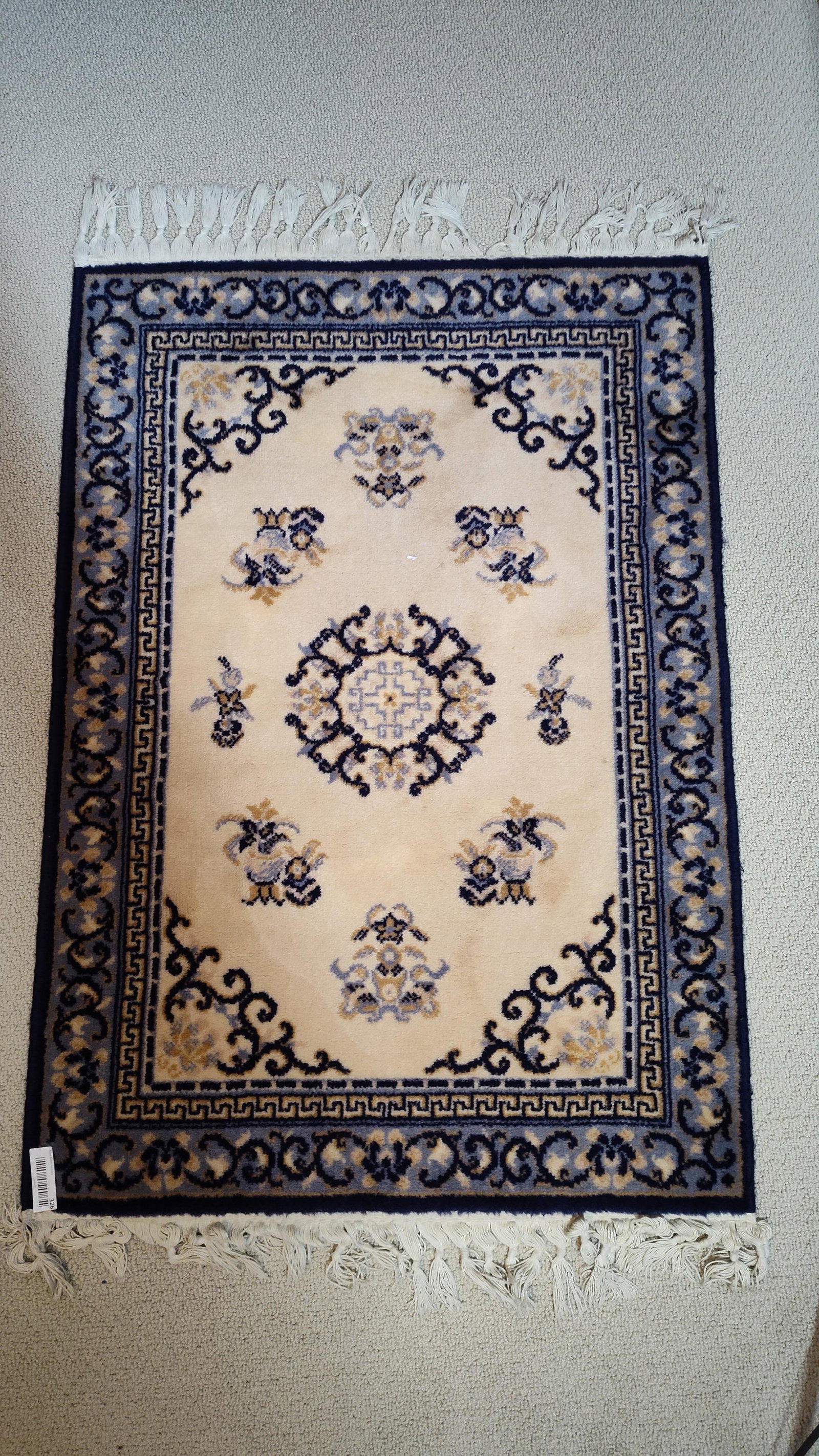 Belgian Area Rug: This Belgian-manufactured area rug was produced for JCPenney and features a classic Ming style pattern. The rug is machine-made with a 100% virgin wool pile. The design consists of a central floral-mo