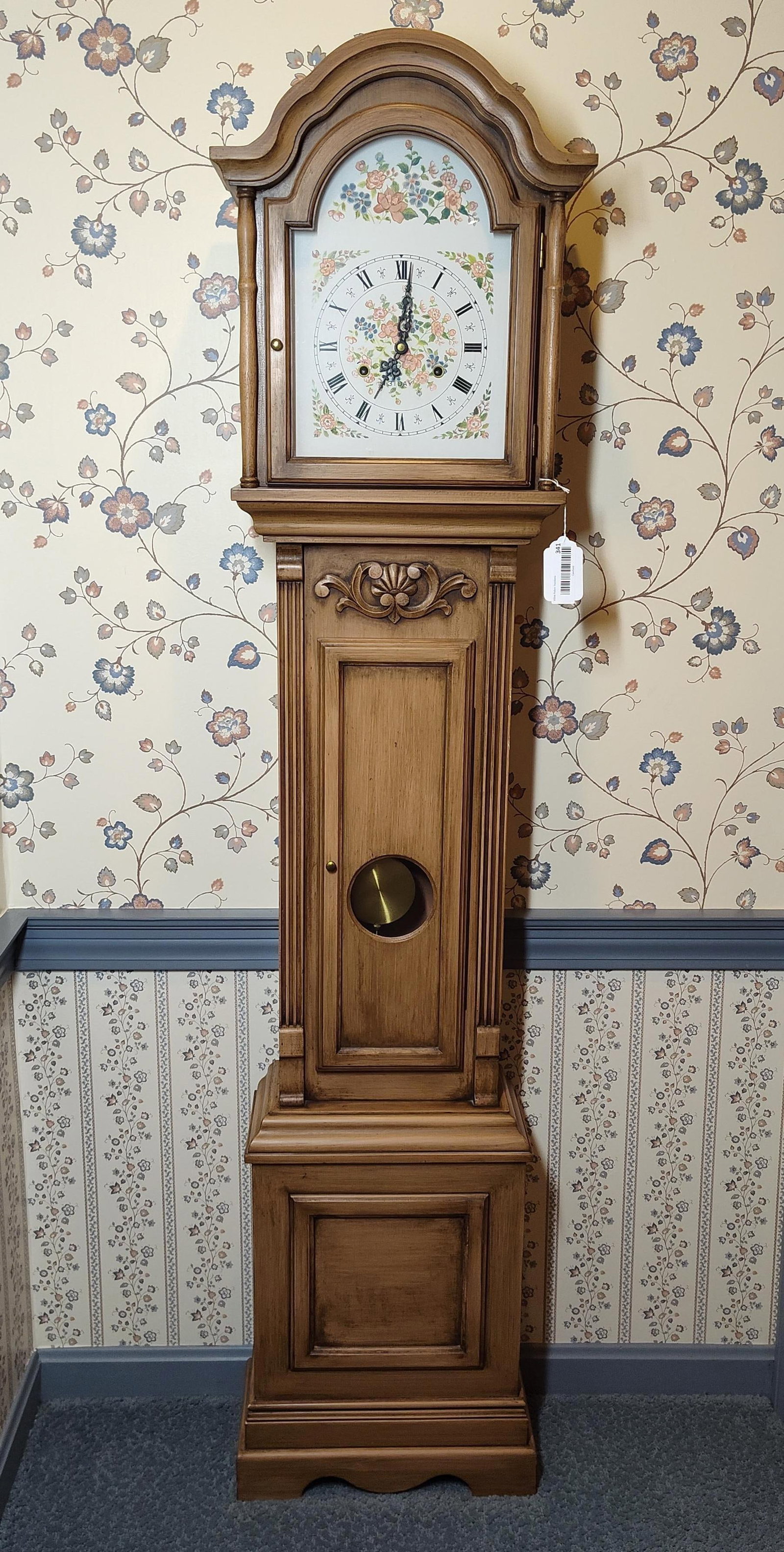 20th C. Baroque Style Wood 31-Day Tall Case Clock: Working condition. 66x 14.5x 8. This 20th-century tall case clock is constructed from a light-toned wood featuring an intentionally distressed or antiqued finish. The hood features a shaped bonnet