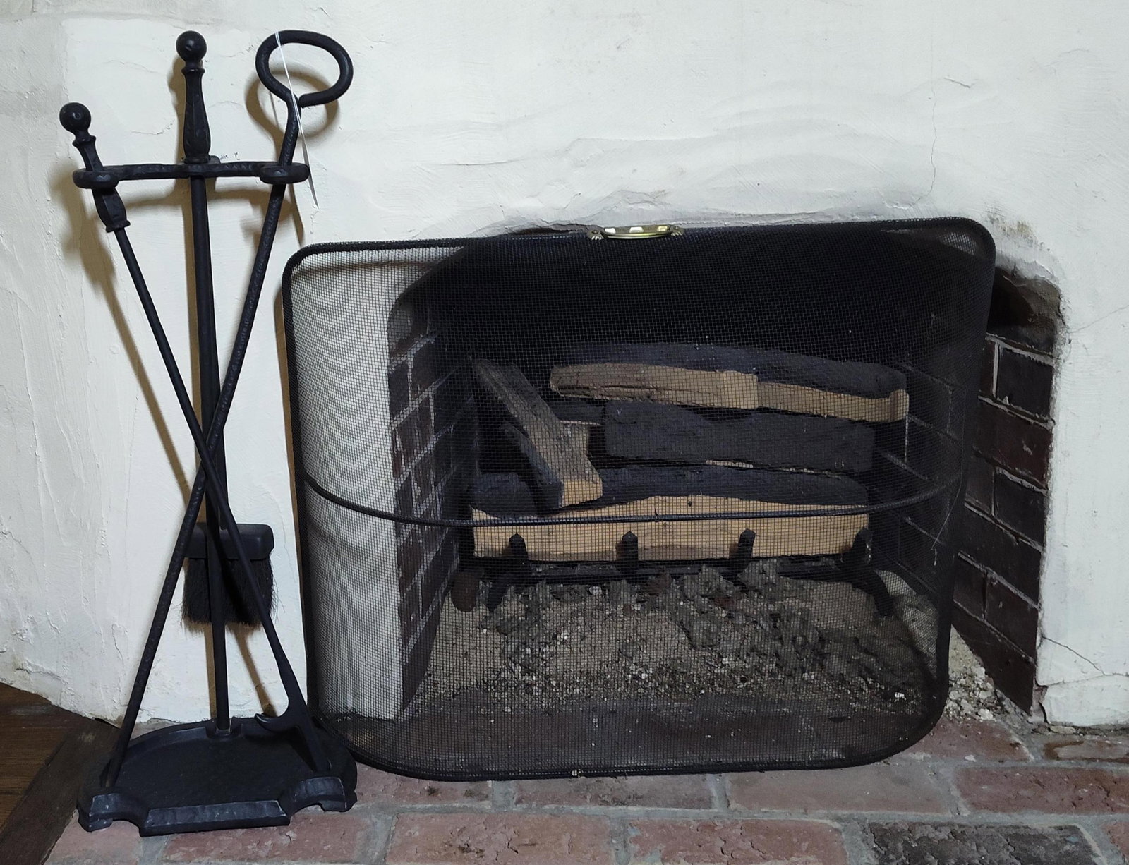 Wrought Iron Fireplace Tool Set & Spark Screen: This hearth collection includes a set of fireplace tools and a spark guard screen designed in a traditional style. The tool set consists of a central stand with an integrated base tray, a shovel, a