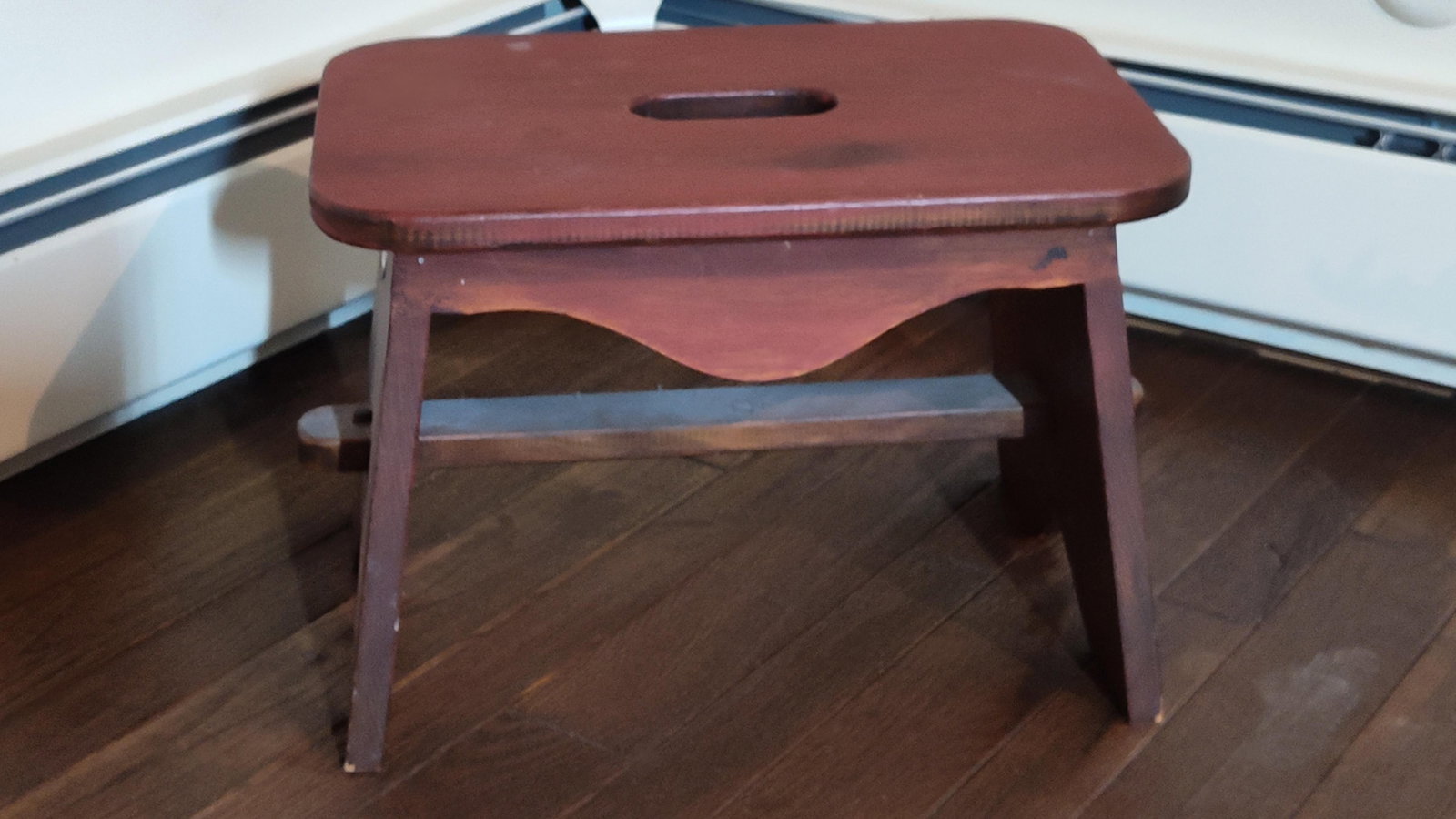 Arts & Crafts Stained Wood Footstool w/ Handgrip: This is an Arts and Crafts style footstool or step stool crafted from stained wood. The design features a rectangular top with rounded corners and a central oval cutout for easy transport. It is