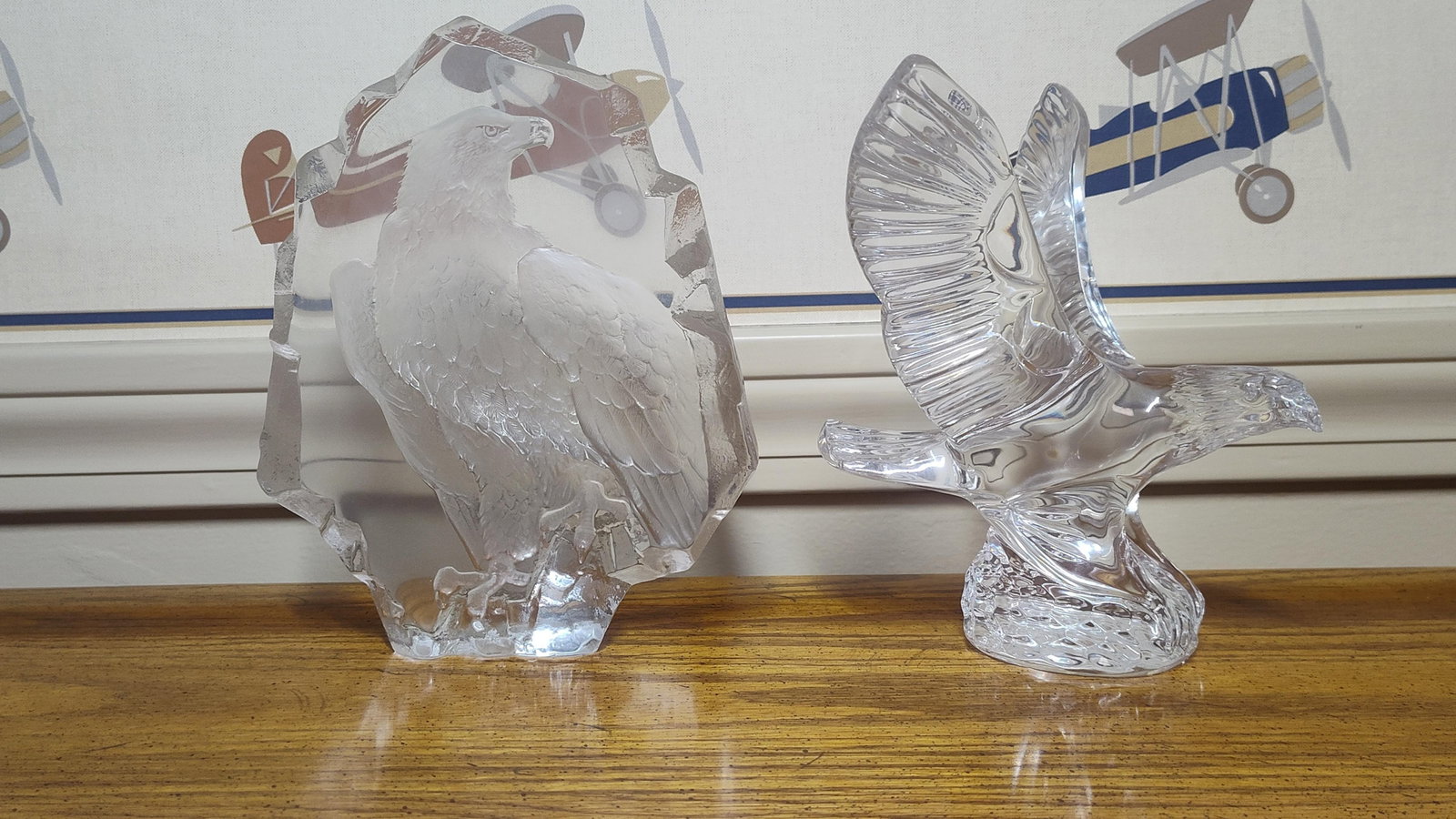 Mats Jonasson Style Crystal Eagle & Intaglio Block: This lot consists of two crystal eagle sculptures. The first is an intaglio relief sculpture depicting a perched eagle in profile with a frosted finish. The eagle is housed within a heavy crystal