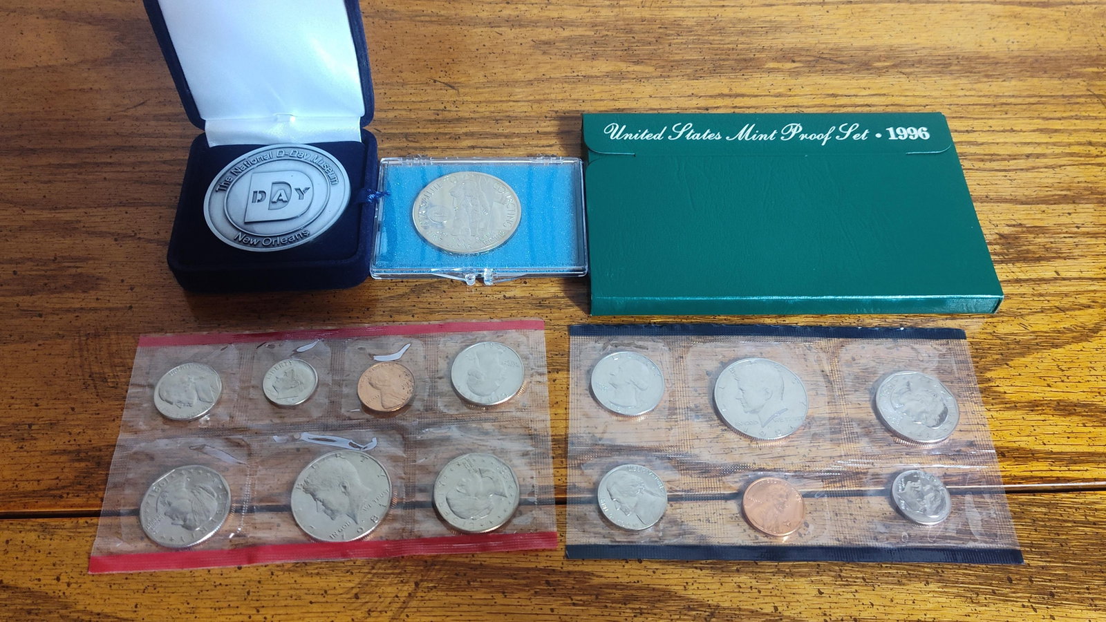 US Mint Coin Sets & Commemorative Medals: This collection features a group of United States Mint coinage sets and commemorative medals. The lot includes a 1996 US Mint Proof Set containing five coins: Lincoln cent, Jefferson nickel, Roosevelt
