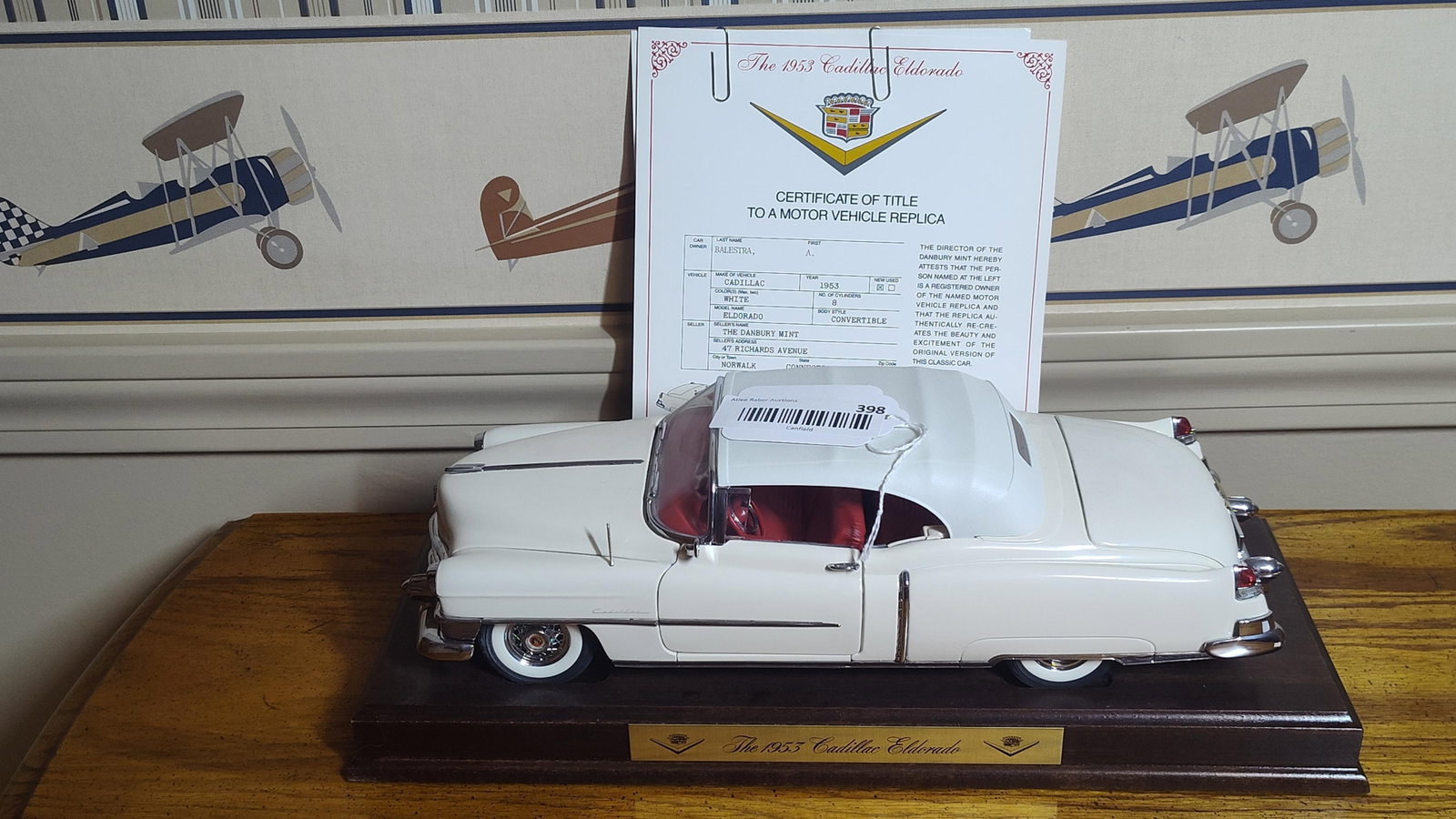 Danbury Mint 1953 Cadillac Eldorado Replica: This is a precision-engineered die-cast metal replica of a 1953 Cadillac Eldorado produced by The Danbury Mint. The model is finished in white with a detailed red interior and includes a removable