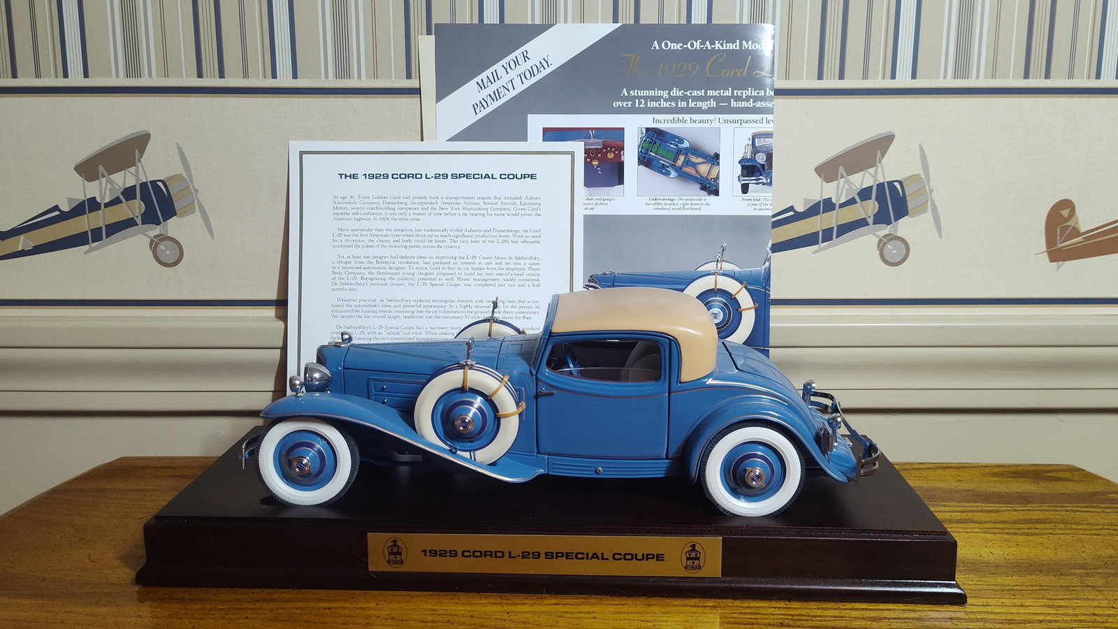 Danbury Mint 1:16 1929 Cord L-29 Special Coupe: This lot features a 1:16 scale die-cast metal replica of the 1929 Cord L-29 Special Coupe produced by The Danbury Mint. The model is finished in blue paint with gold pinstripe detailing and a tan
