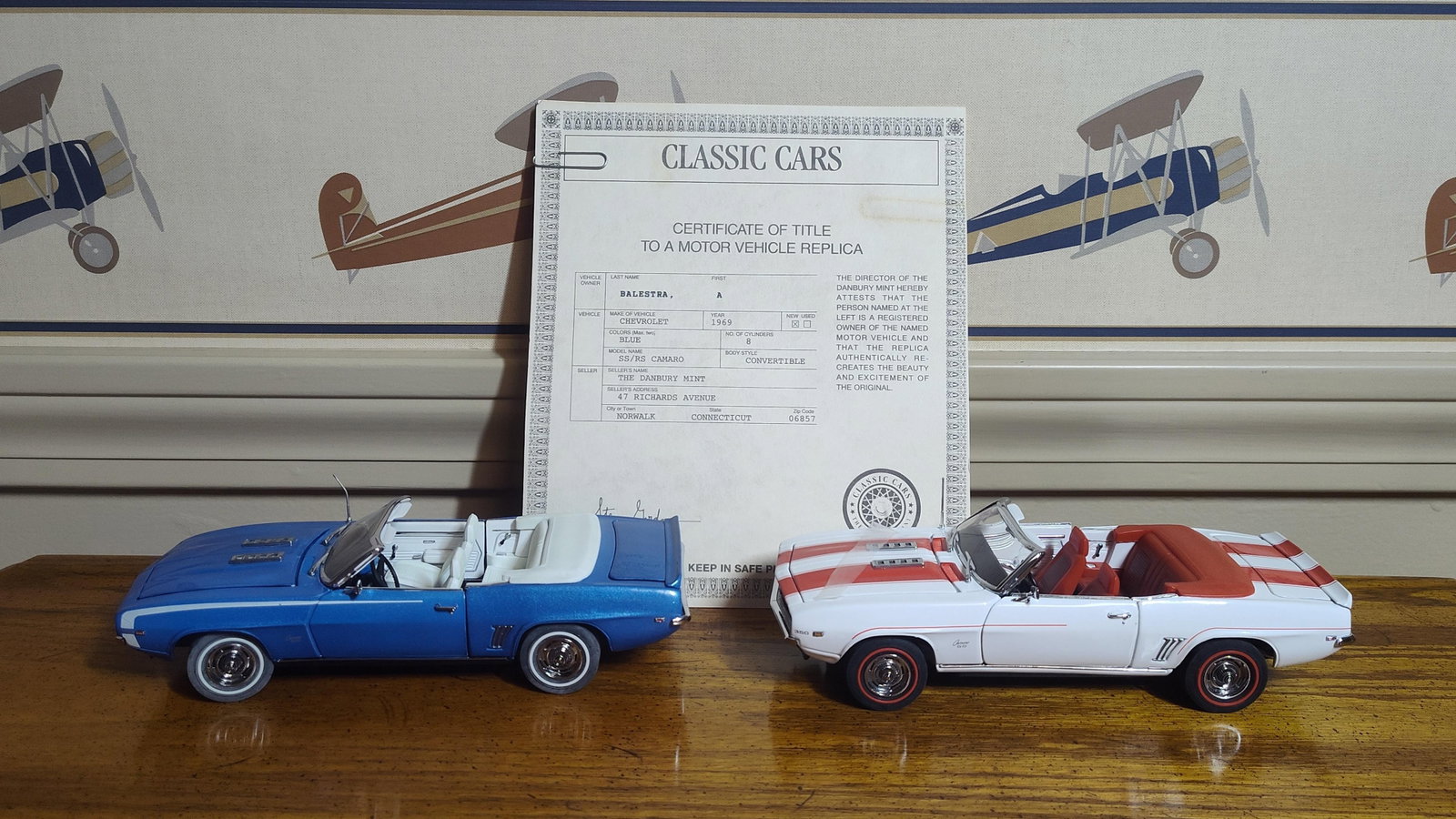 Pair Danbury Mint 1:24 1969 Chevrolet Camaro Conv: A pair of highly detailed 1:24 scale model car replicas manufactured by The Danbury Mint, representing two variations of the 1969 Chevrolet Camaro. Both models are constructed of die-cast metal with