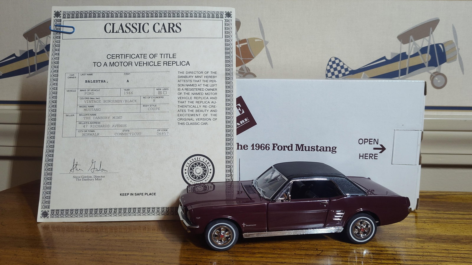 Danbury Mint 1966 Ford Mustang Coupe: This precision scale replica represents a 1966 Ford Mustang Coupe manufactured by The Danbury Mint. The model is constructed from die-cast metal and finished in Vintage Burgundy with a textured black