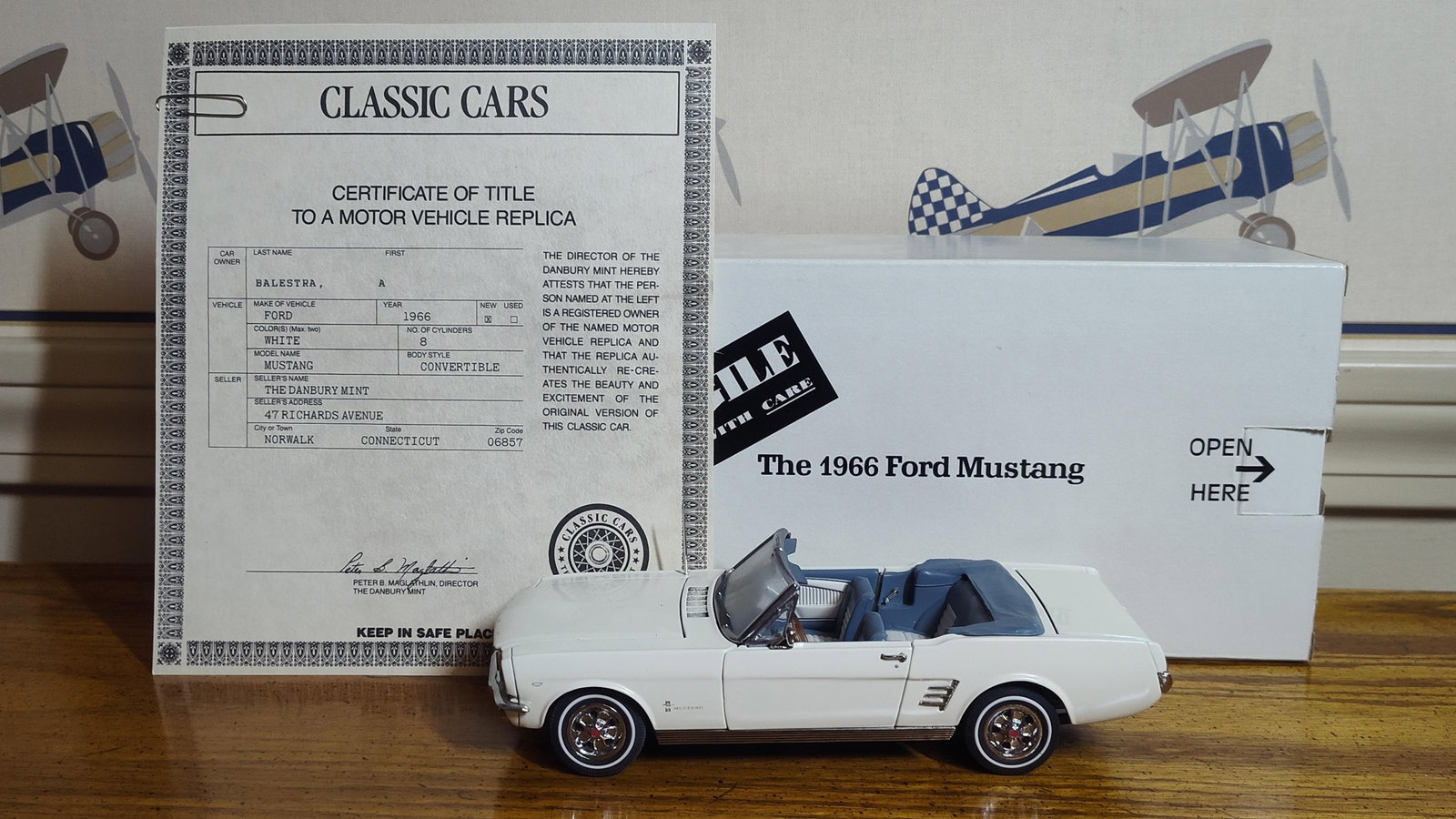 Danbury Mint 1966 Ford Mustang Convertible w/ Box: This lot features a 1:24 scale replica of a 1966 Ford Mustang Convertible manufactured by The Danbury Mint. The model is constructed from die-cast metal and features a white exterior finish with a