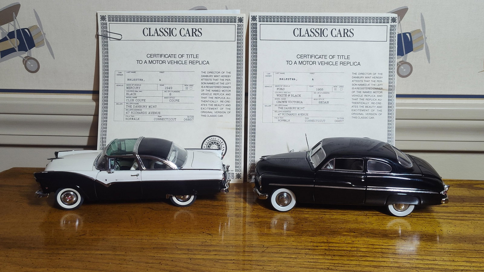 Pair Danbury Mint 1949 Mercury & 1955 Ford Models: This pair of 1:24 scale precision models was produced by The Danbury Mint and includes a 1949 Mercury Club Coupe and a 1955 Ford Crown Victoria. Both are constructed of die-cast metal with plastic
