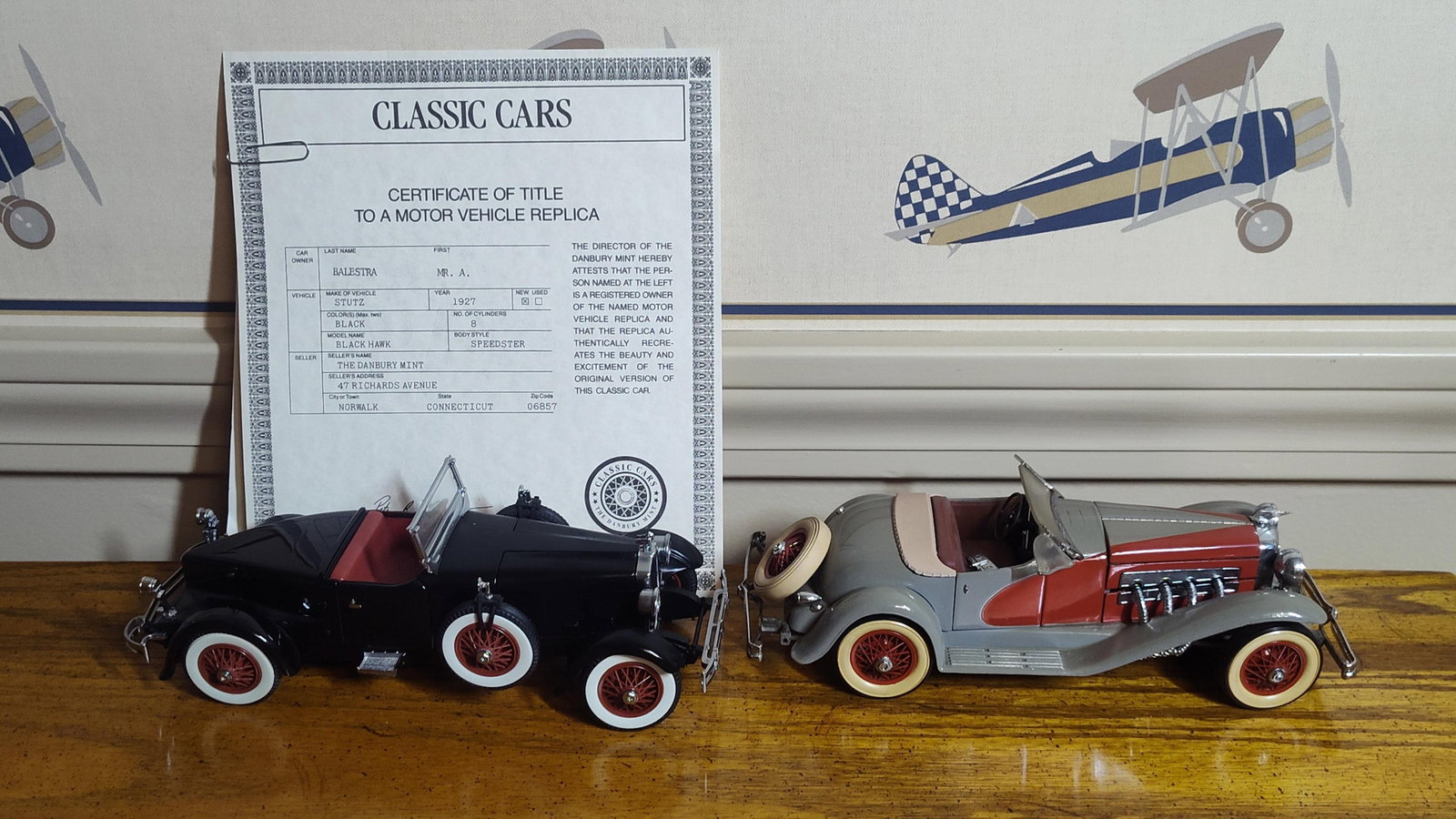 Pair Danbury Mint Stutz & Duesenberg Model Cars: This lot features two precision model car replicas produced by The Danbury Mint in approximately 1:24 scale. The collection consists of a 1927 Stutz Black Hawk Speedster and a 1935 Duesenberg SSJ