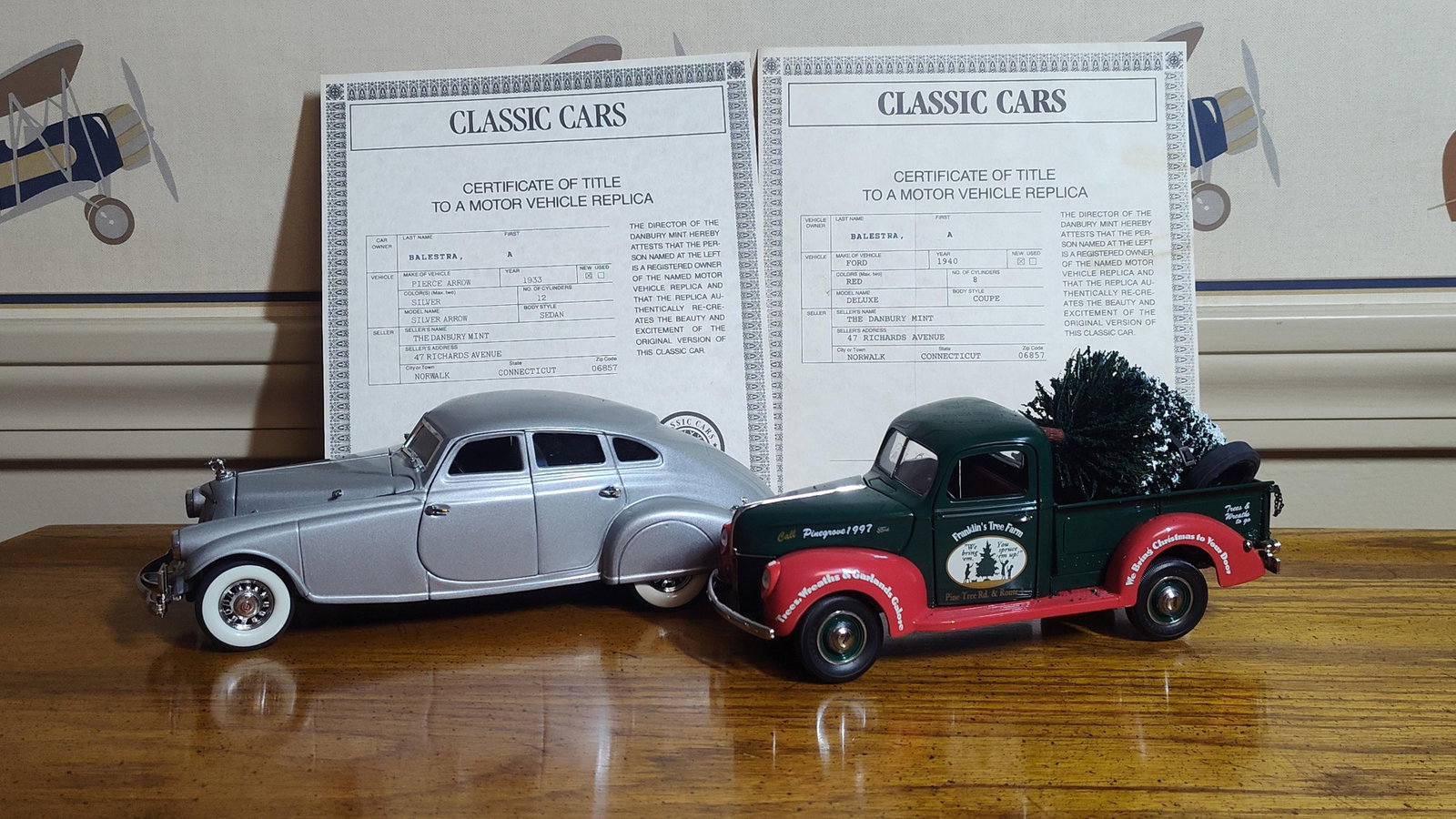 Pair Danbury Mint 1:24 Pierce Arrow & Ford Pickup: This lot features two 1:24 scale model vehicles manufactured by The Danbury Mint, constructed of die-cast metal with plastic and rubber components. The first vehicle is a 1933 Pierce Arrow Silver