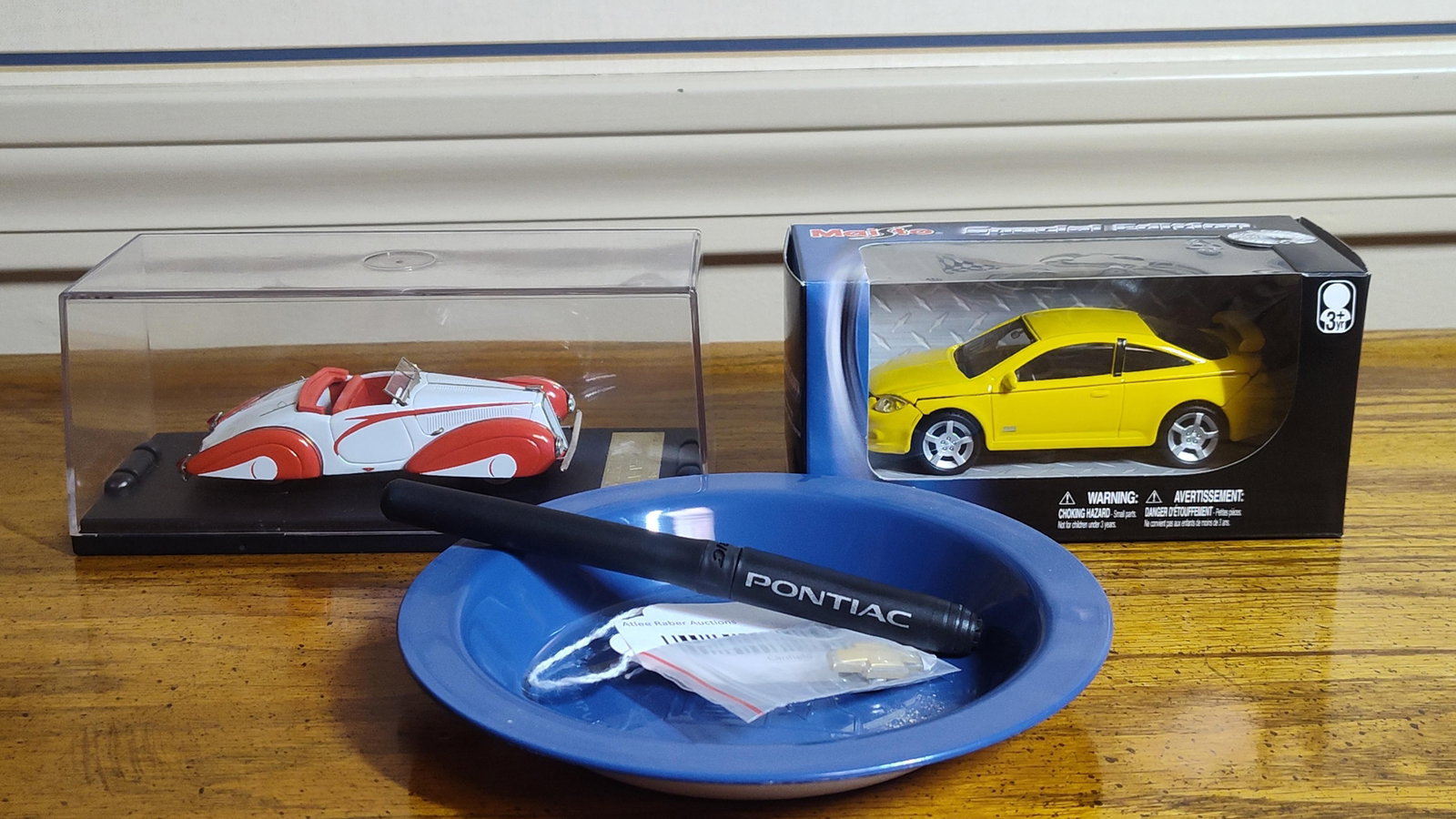 General Motors Models & Promotional Memorabilia: This collection features die-cast vehicle models and various items of General Motors promotional memorabilia. Included is a Maisto Special Edition yellow Chevrolet Cobalt SS, which remains in its orig